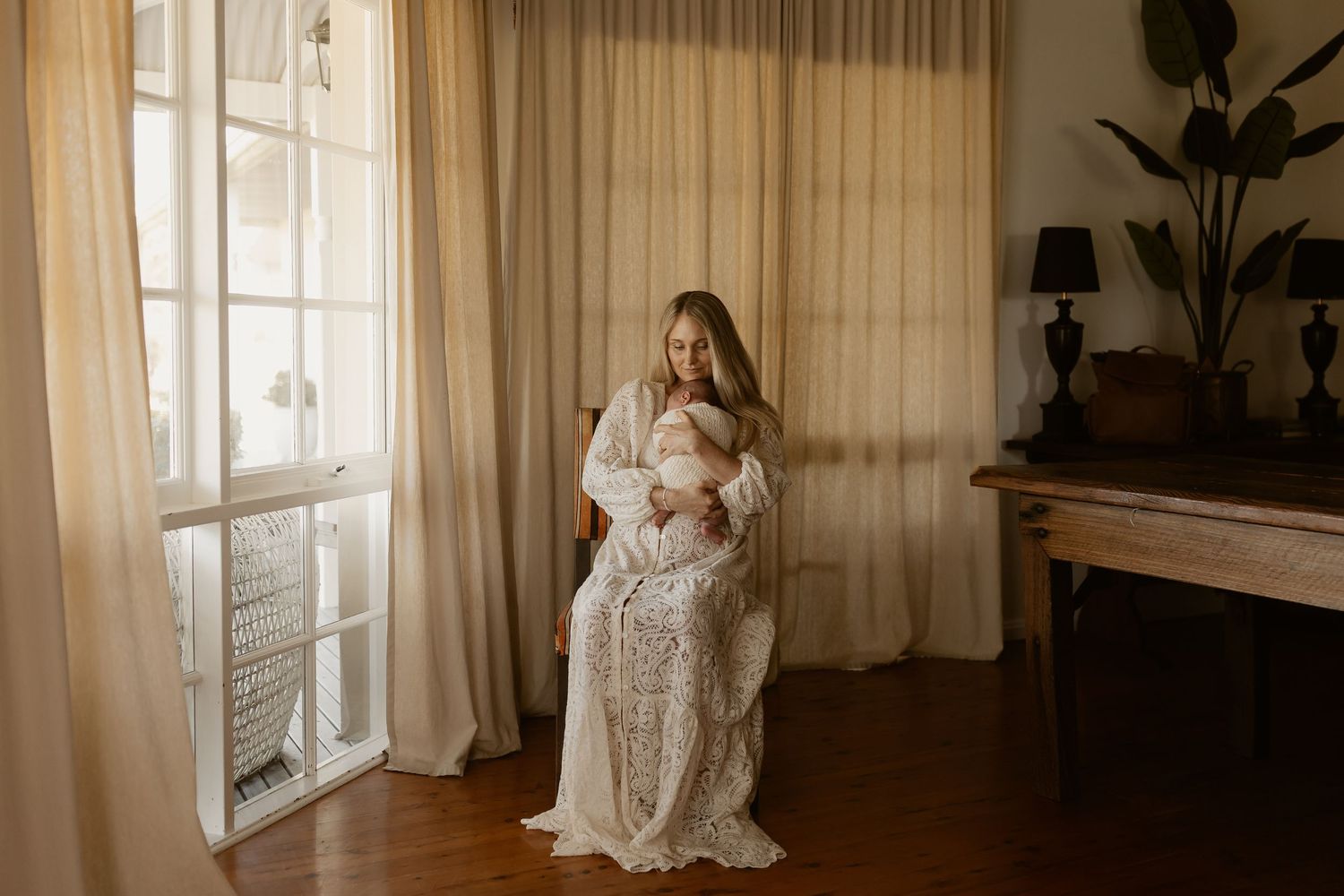 A series of romantic bridal photos captured in a sunlit room with light curtains and hardwood floors.