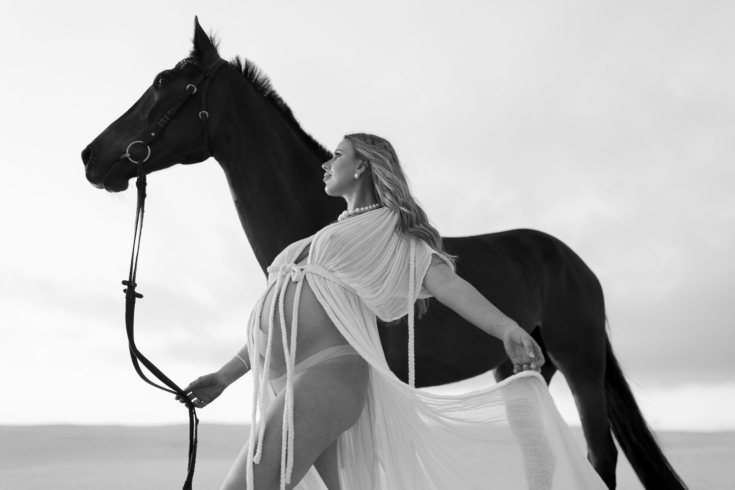 Artistic black and white photos of woman and horse creating dramatic silhouettes in desert setting.