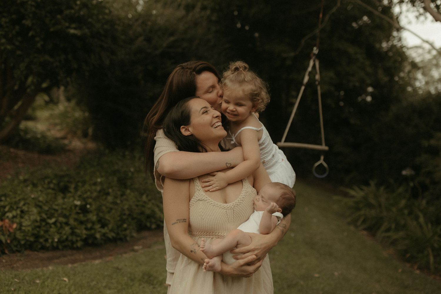 Candid family moments captured in a natural outdoor setting with warm lighting.