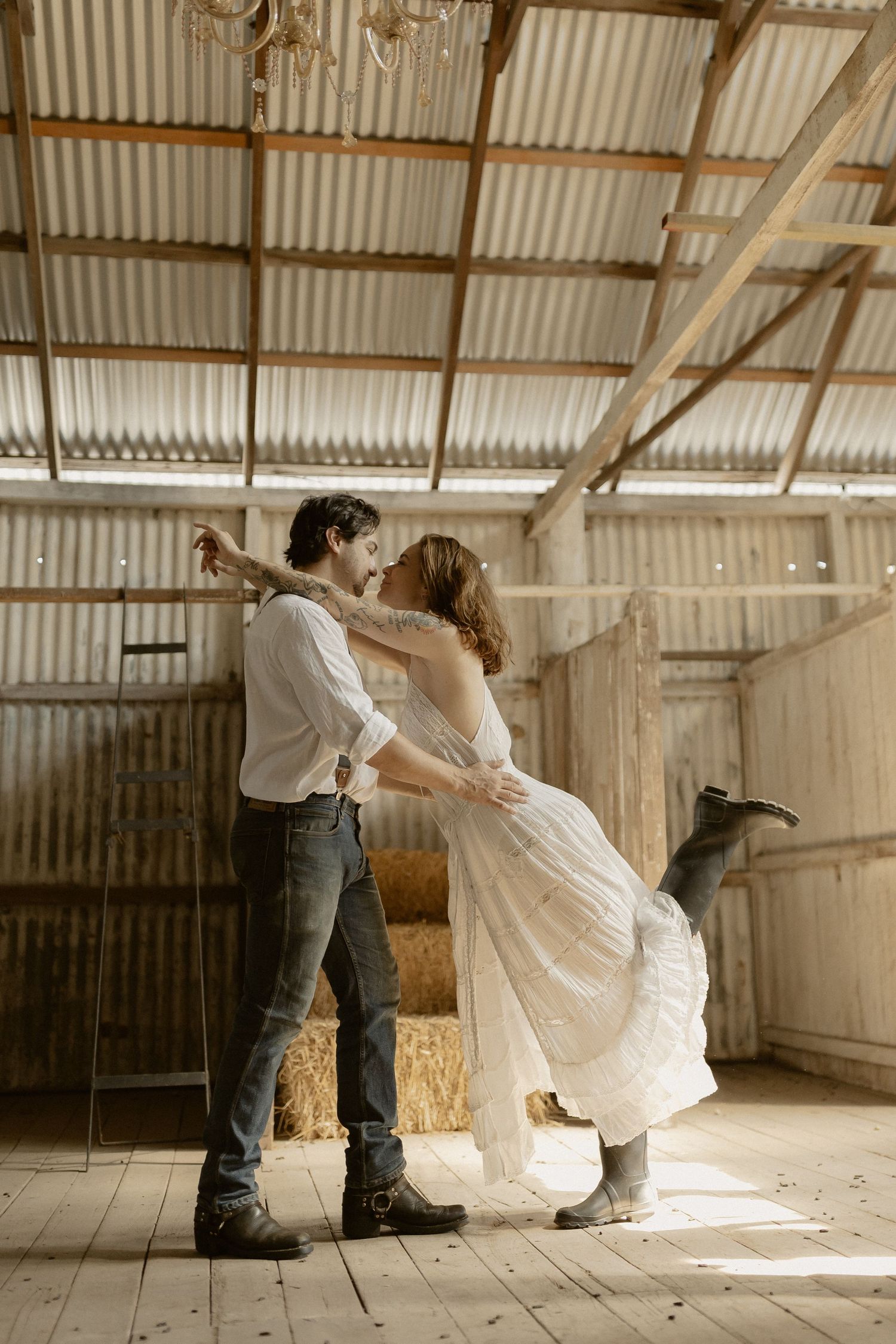 Graceful dance sequence performed in an old barn with dramatic natural lighting.