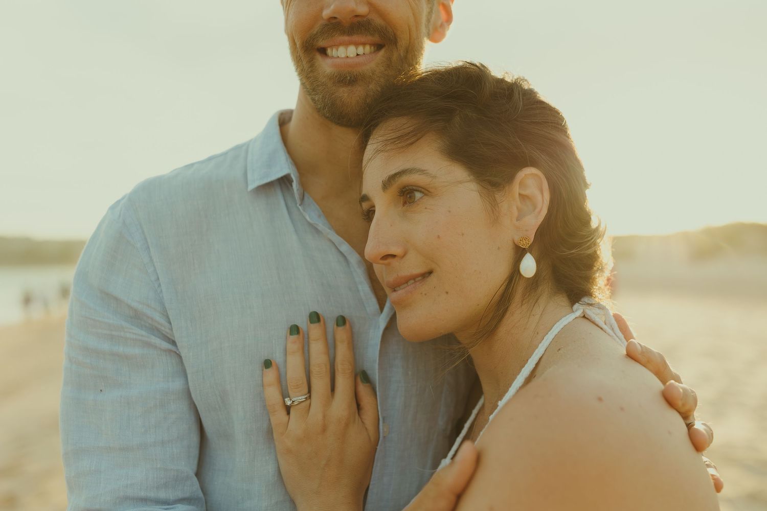 Loving couple sharing affectionate moments during beach photoshoot.