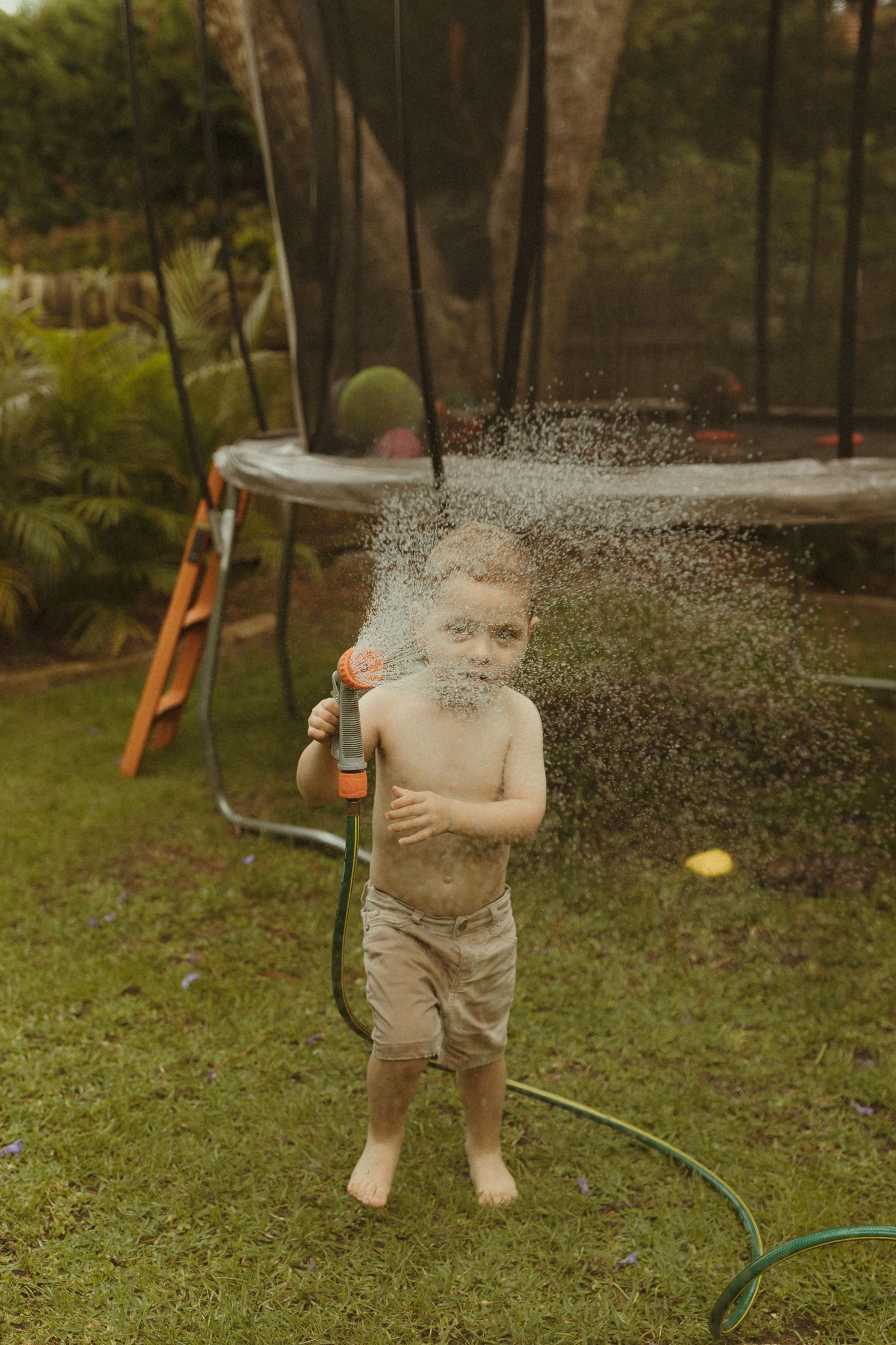 Water sprays create a magical effect in this backyard summer scene.