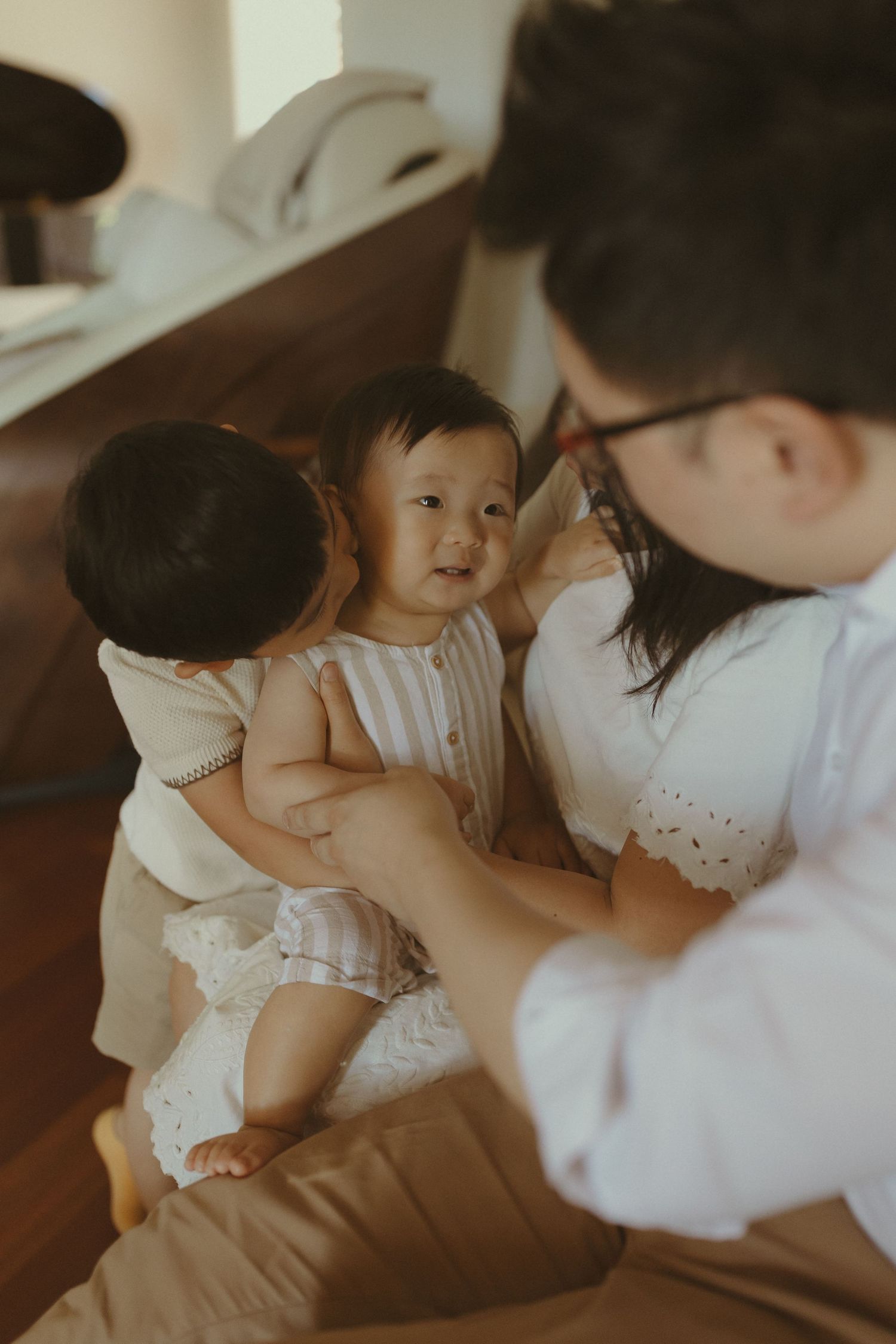 A tender family moment captured in warm, intimate lighting.