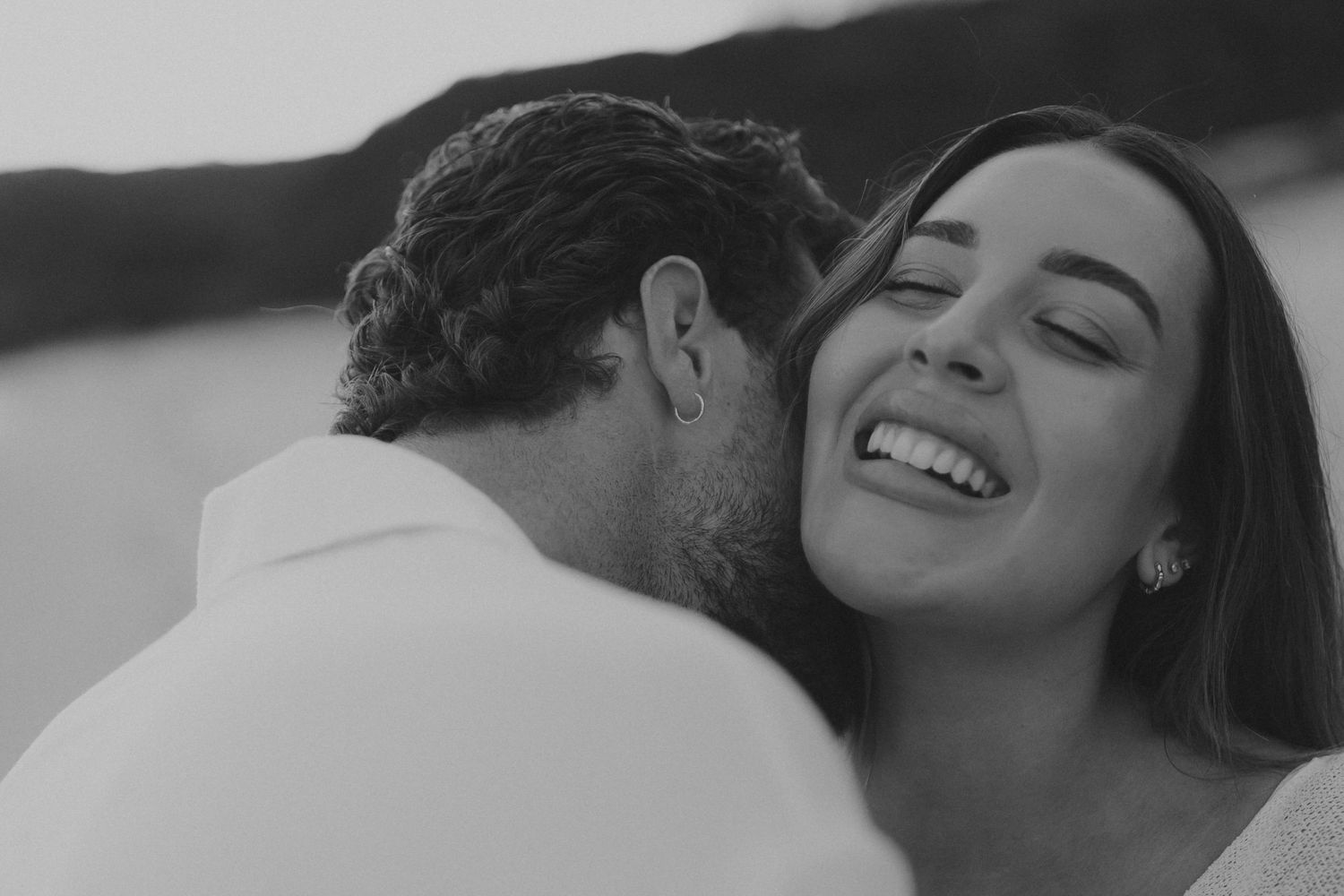 Black and white photo series showing tender romantic moments between a couple embracing and laughing together.