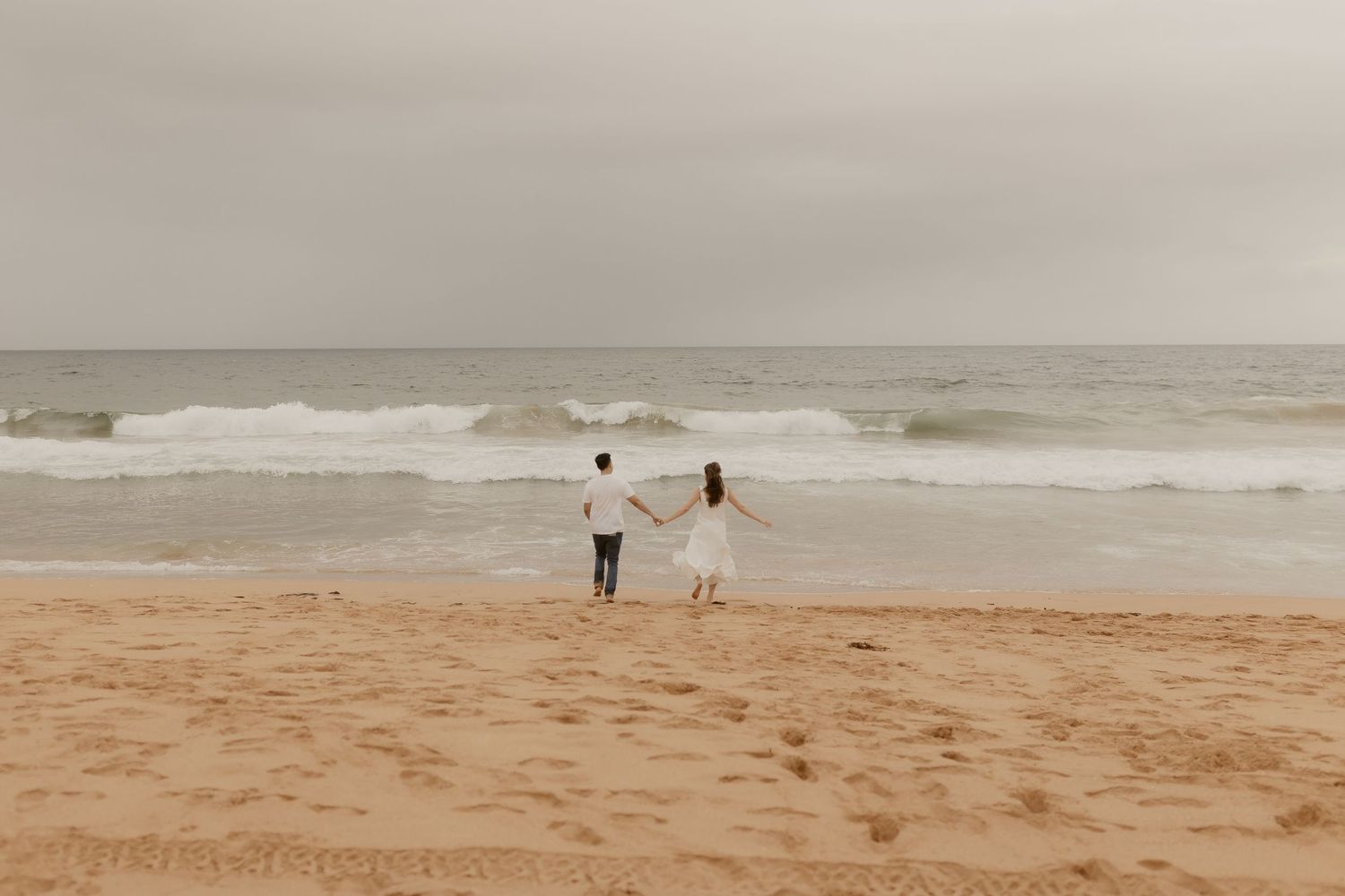 Moody seascape with crashing waves and overcast skies at a remote beach during stormy weather.