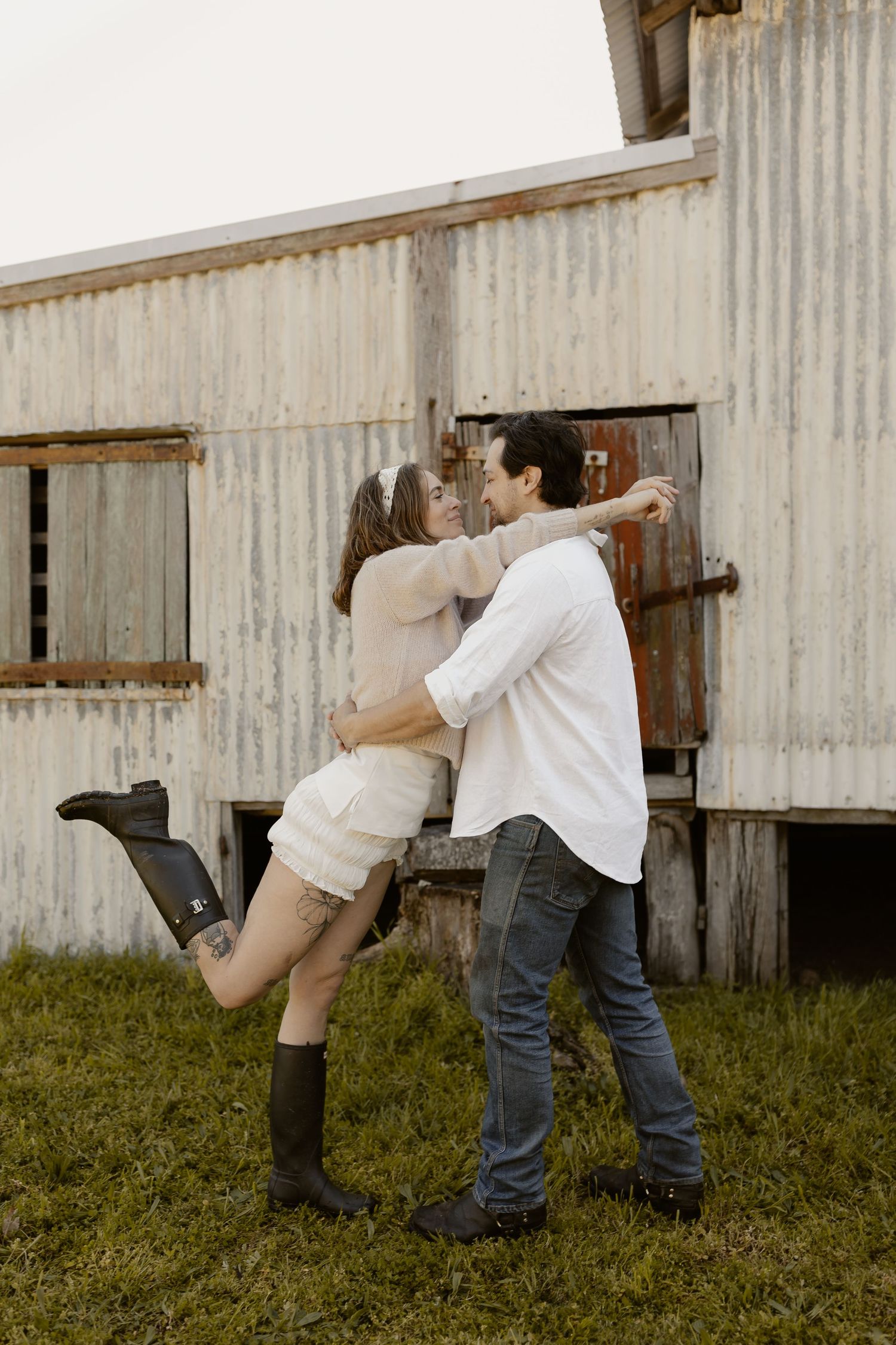 Artistic sequence showing movement against a rustic barn wall in natural lighting.