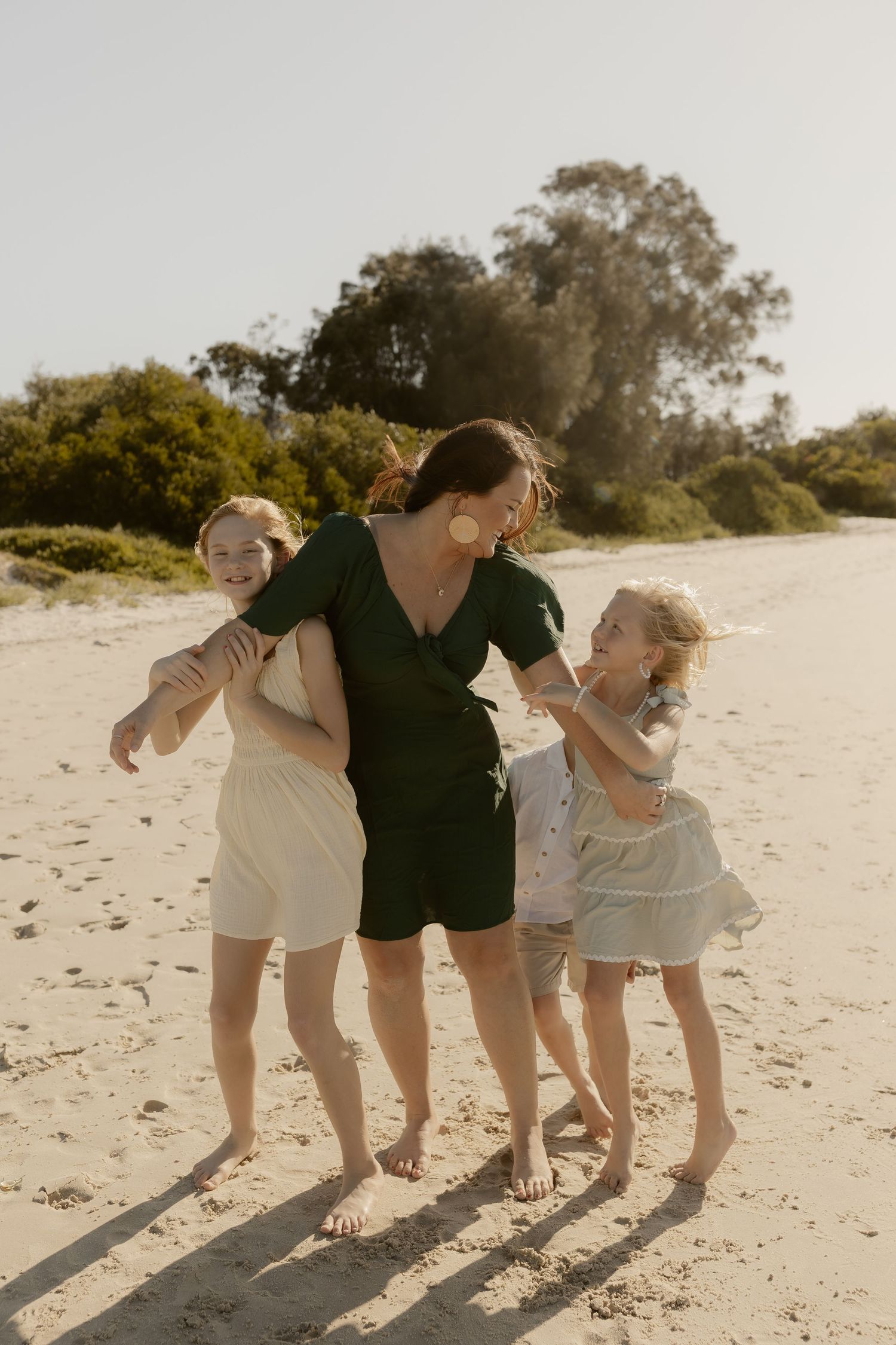 A series of candid beach photos showing a group bending down and laughing together.
