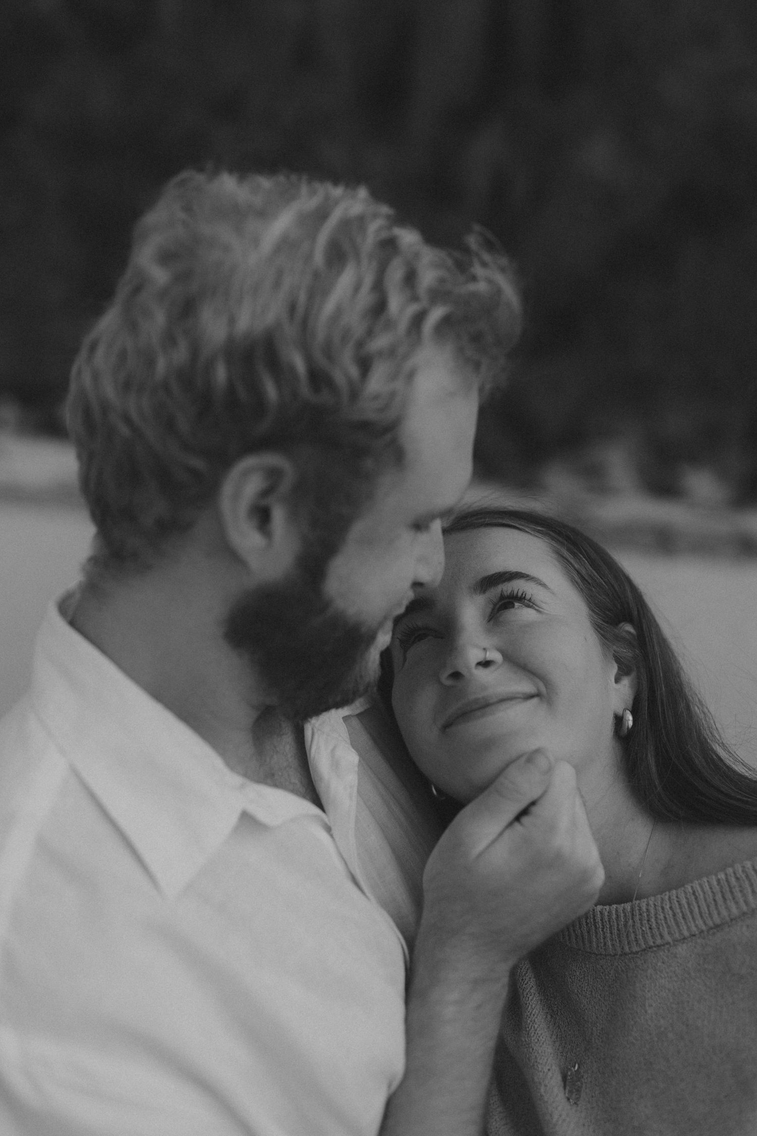 Intimate black and white portrait of couple sharing tender moments and embraces together.