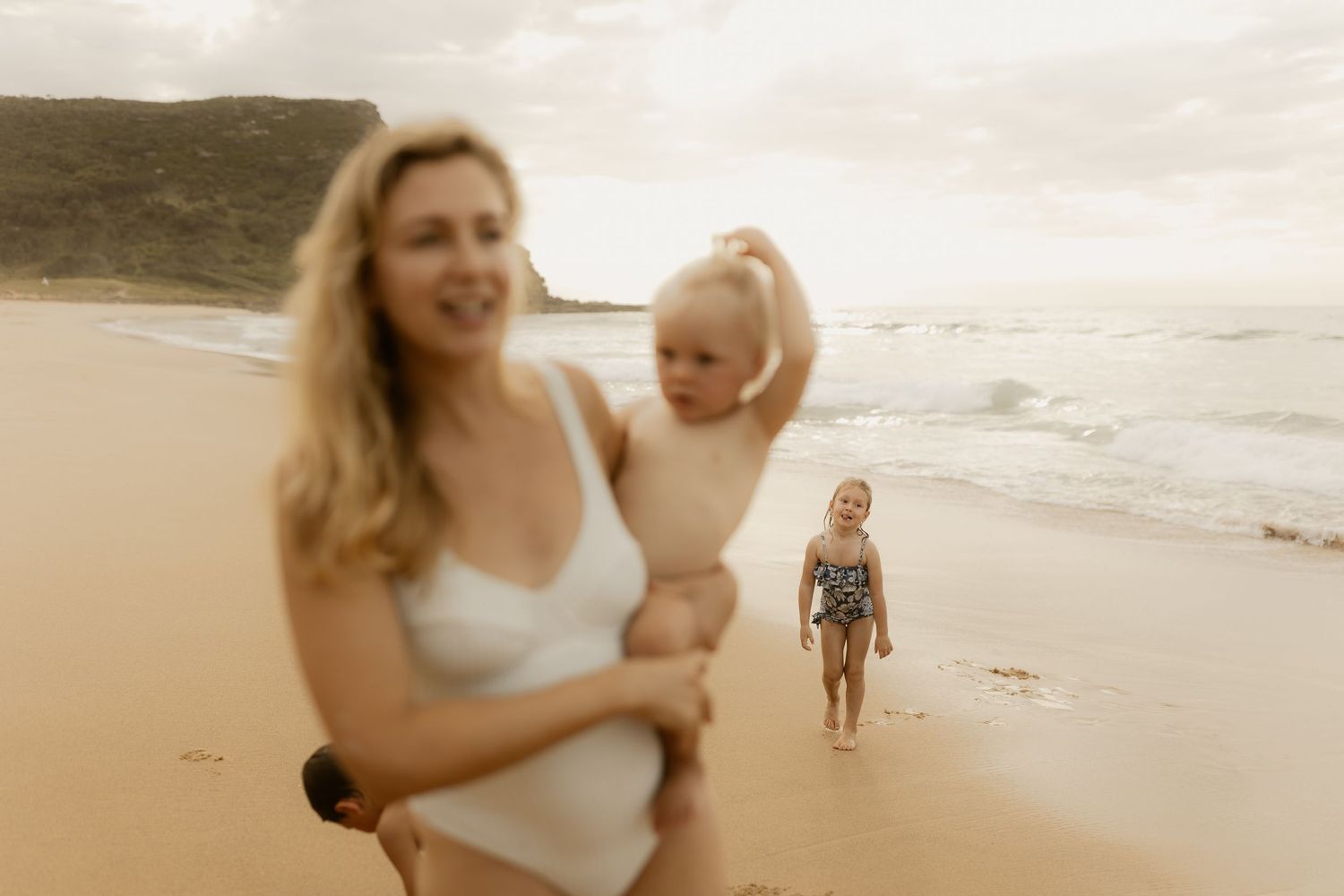 A joyful beach scene with people enjoying a sunny day along the shoreline.
