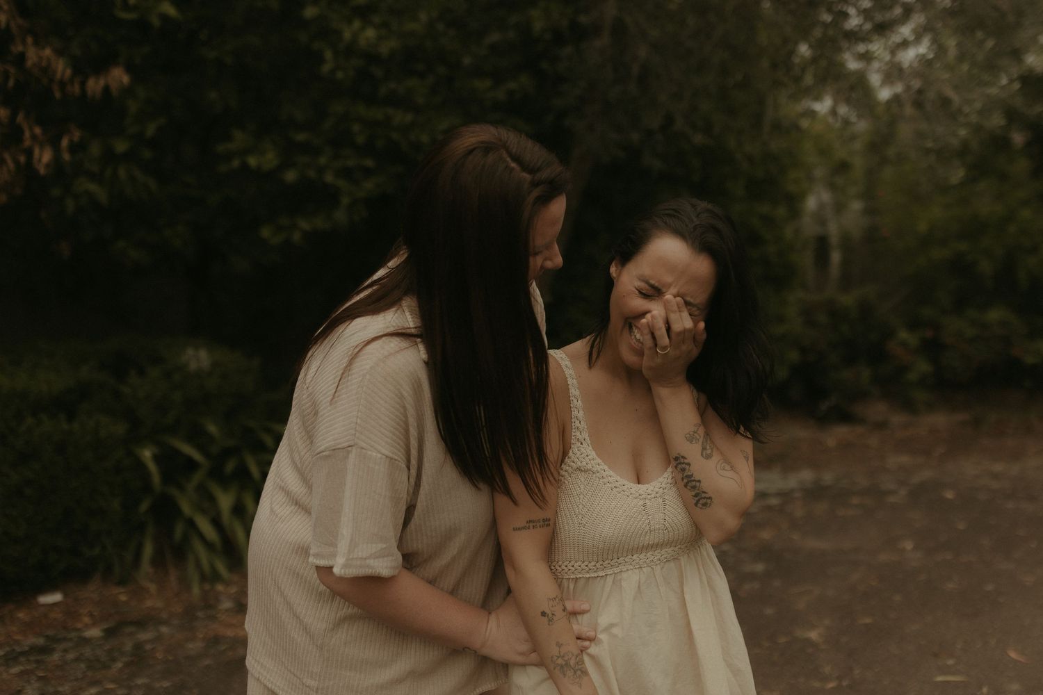 Intimate outdoor family photoshoot with moody lighting and natural backdrop.