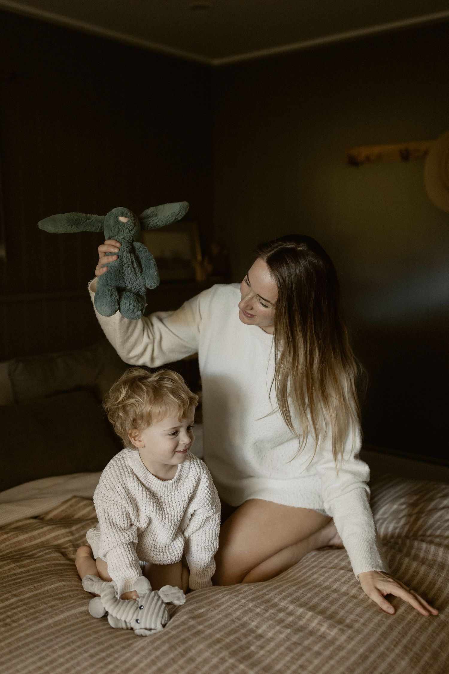 Cozy bedroom scene with plush stuffed animal and warm lighting creating an intimate atmosphere.
