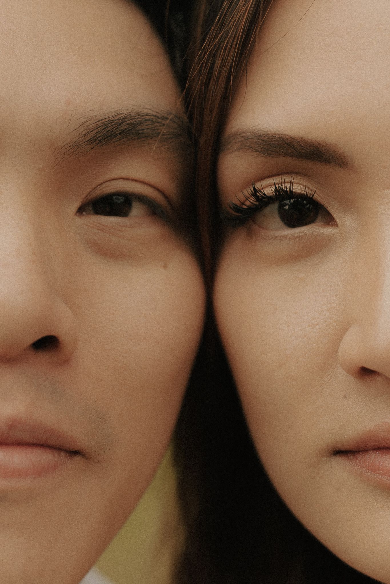 Close-up artistic portrait showing partial facial features in a soft, minimalist style with warm lighting.