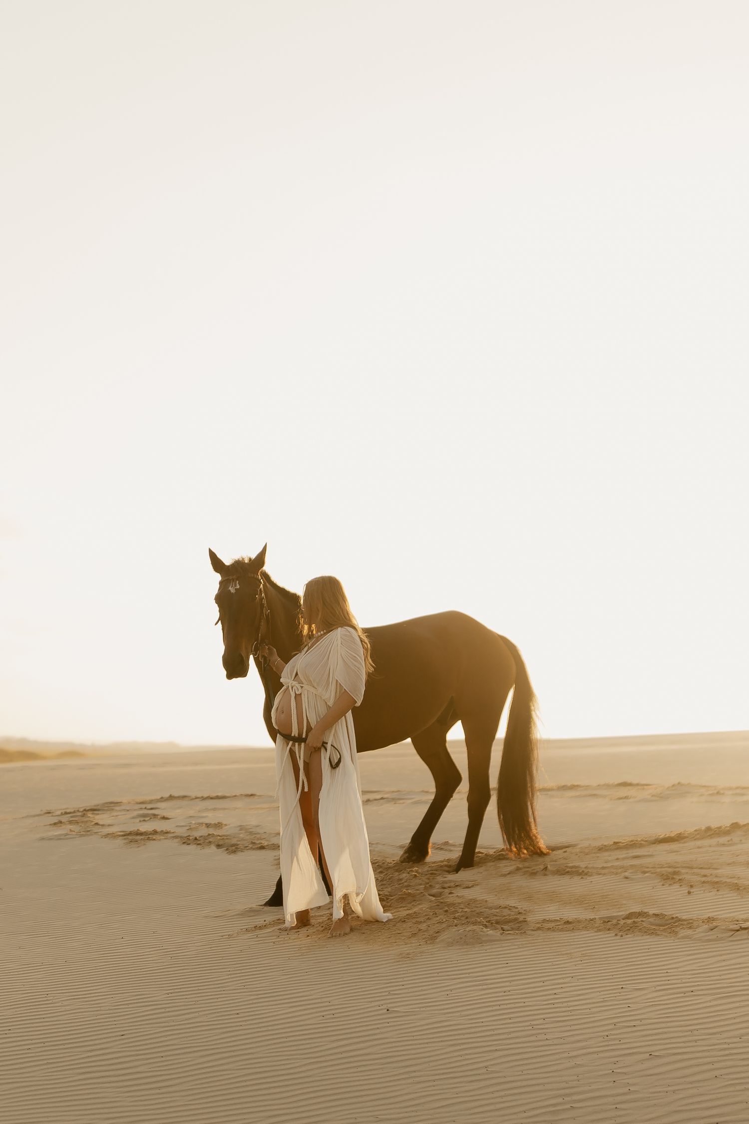 A collection of desert scenes with a figure in flowing white dress standing with a dark horse against sand dunes.