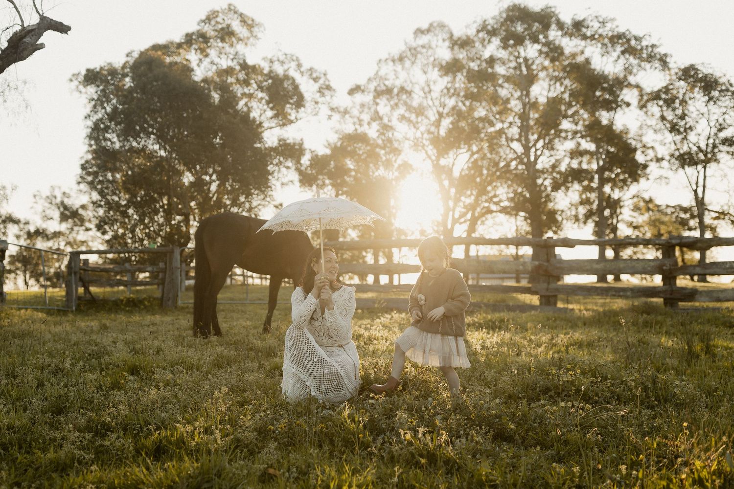 A dreamy sunset landscape with silhouettes dancing in a flower-filled meadow.