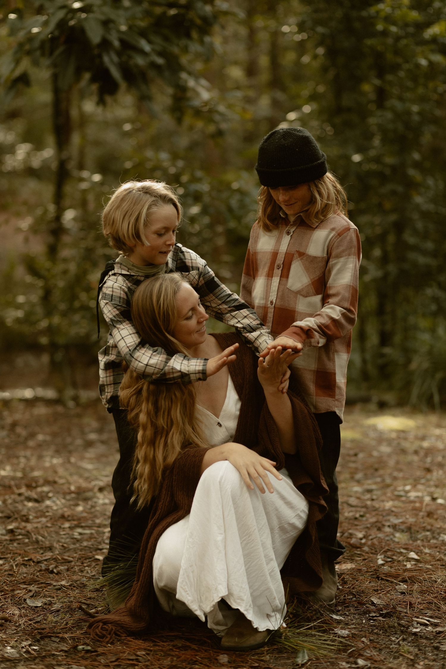 Playtime in the autumn forest with children wearing vintage-inspired clothing.