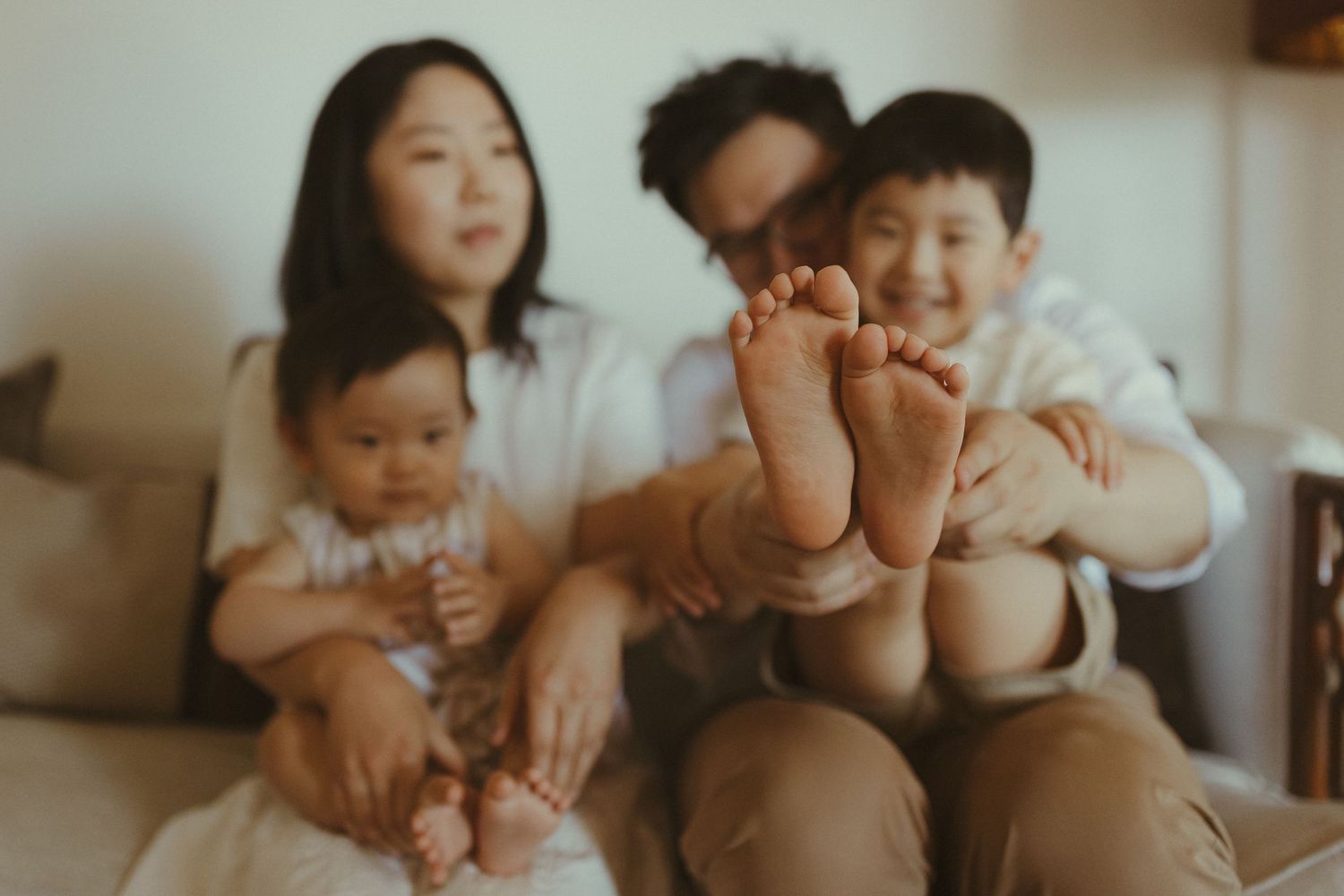 Warm-toned candid family moments captured in a series of intimate indoor photographs.