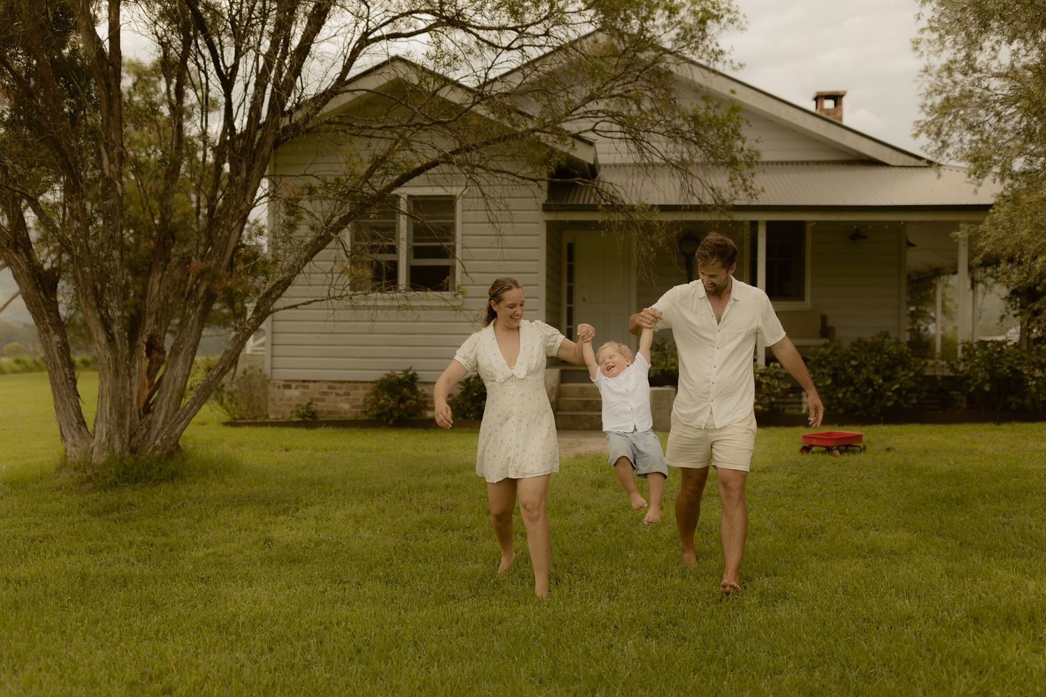 People running together through a grassy yard in white clothing, shown in a series of five connected images.