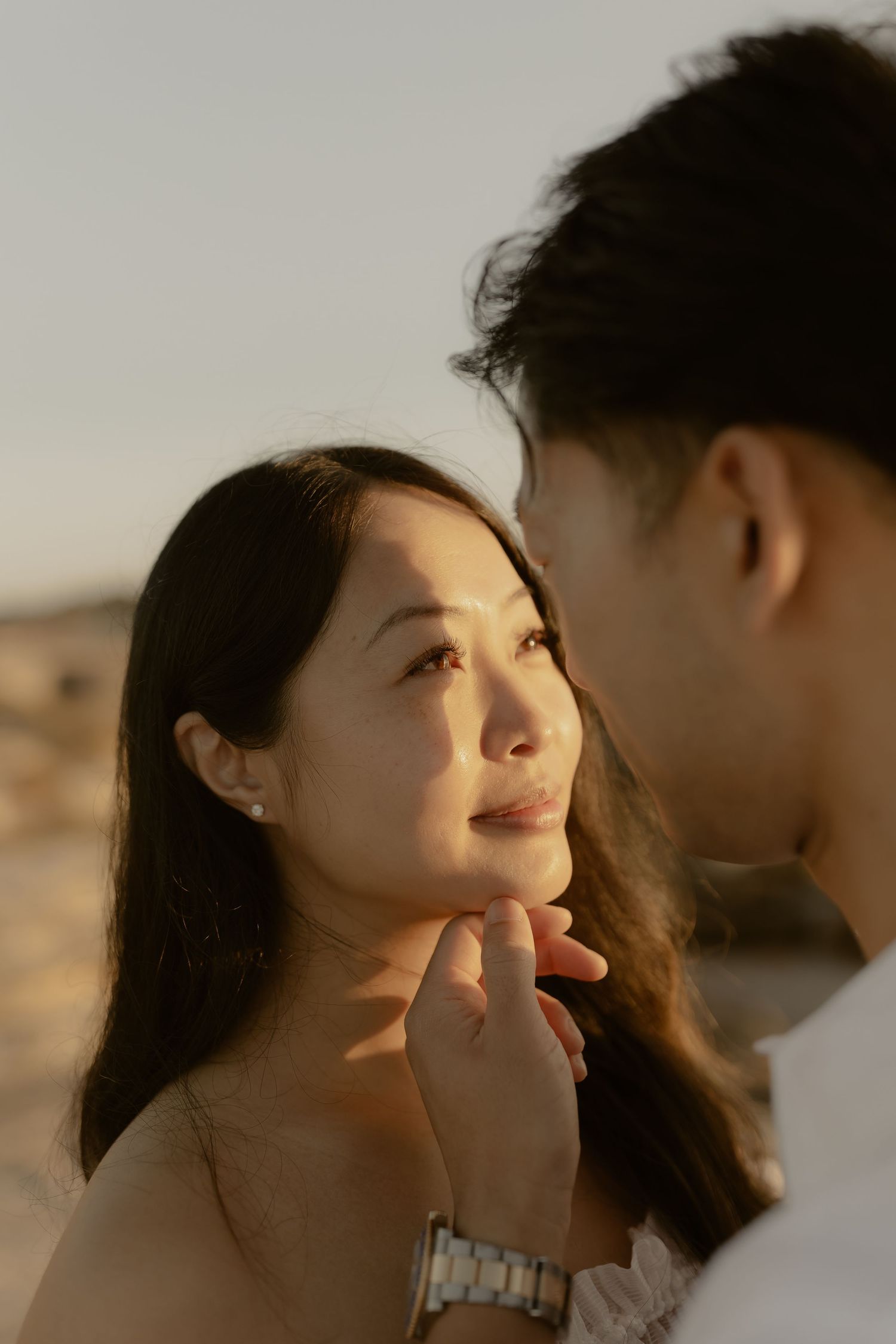 Intimate close-up shots of a couple sharing tender moments against soft natural lighting.
