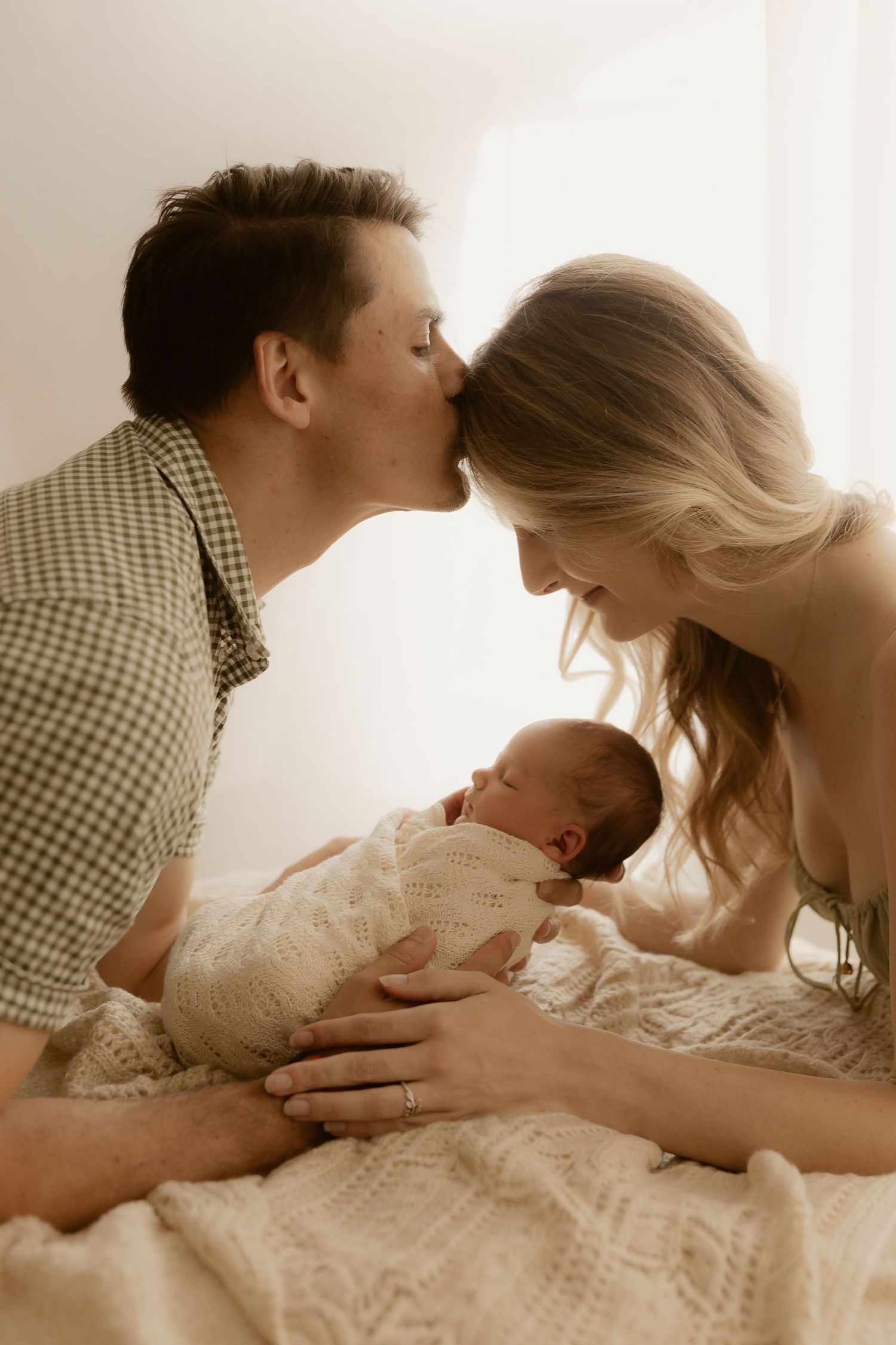 Parents sharing loving moments with their newborn baby in a series of warm-toned photographs.