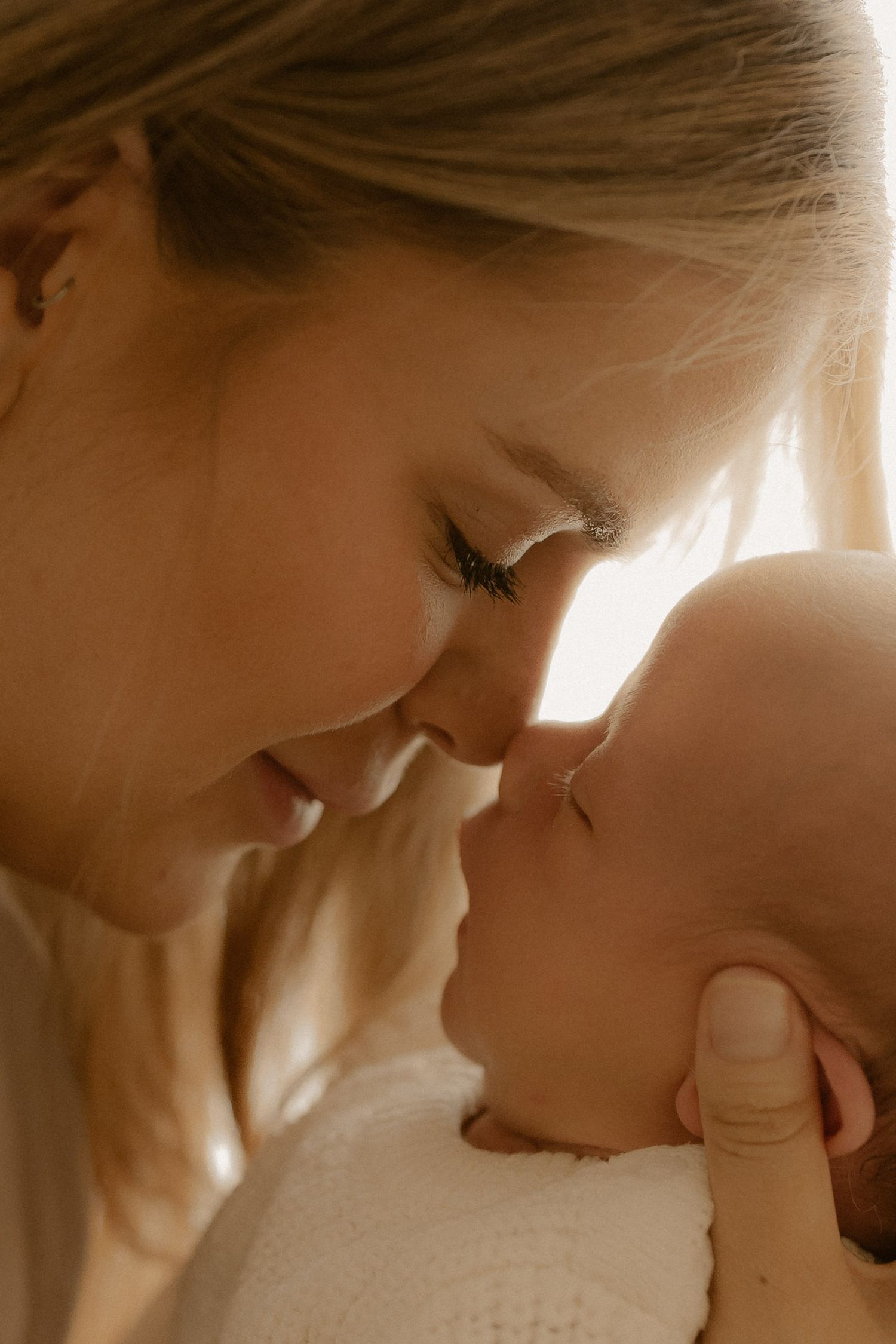 A tender moment between two people sharing a close embrace in soft sepia lighting.