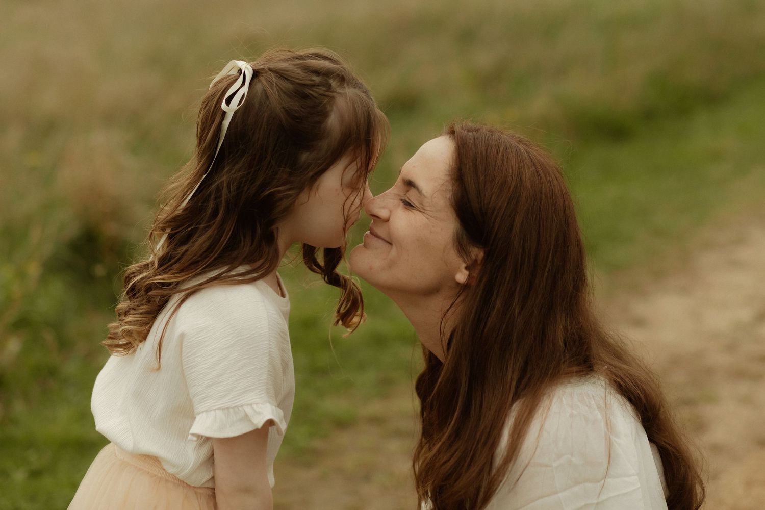 A tender moment shared between family members in an outdoor setting.
