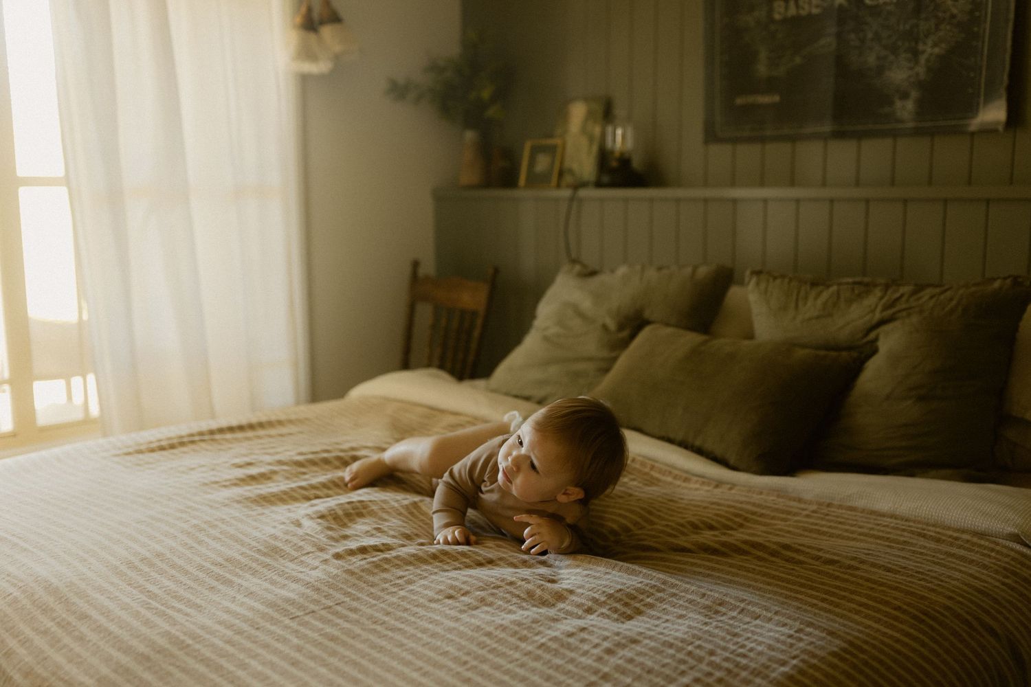 Cozy bedroom photography scene with natural window light creating warm atmosphere.
