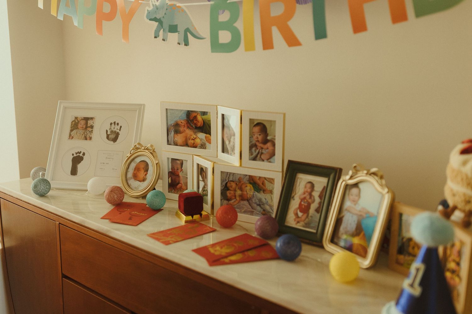 A colorful 'Happy Birthday' banner decorates a wall with photos and artwork.