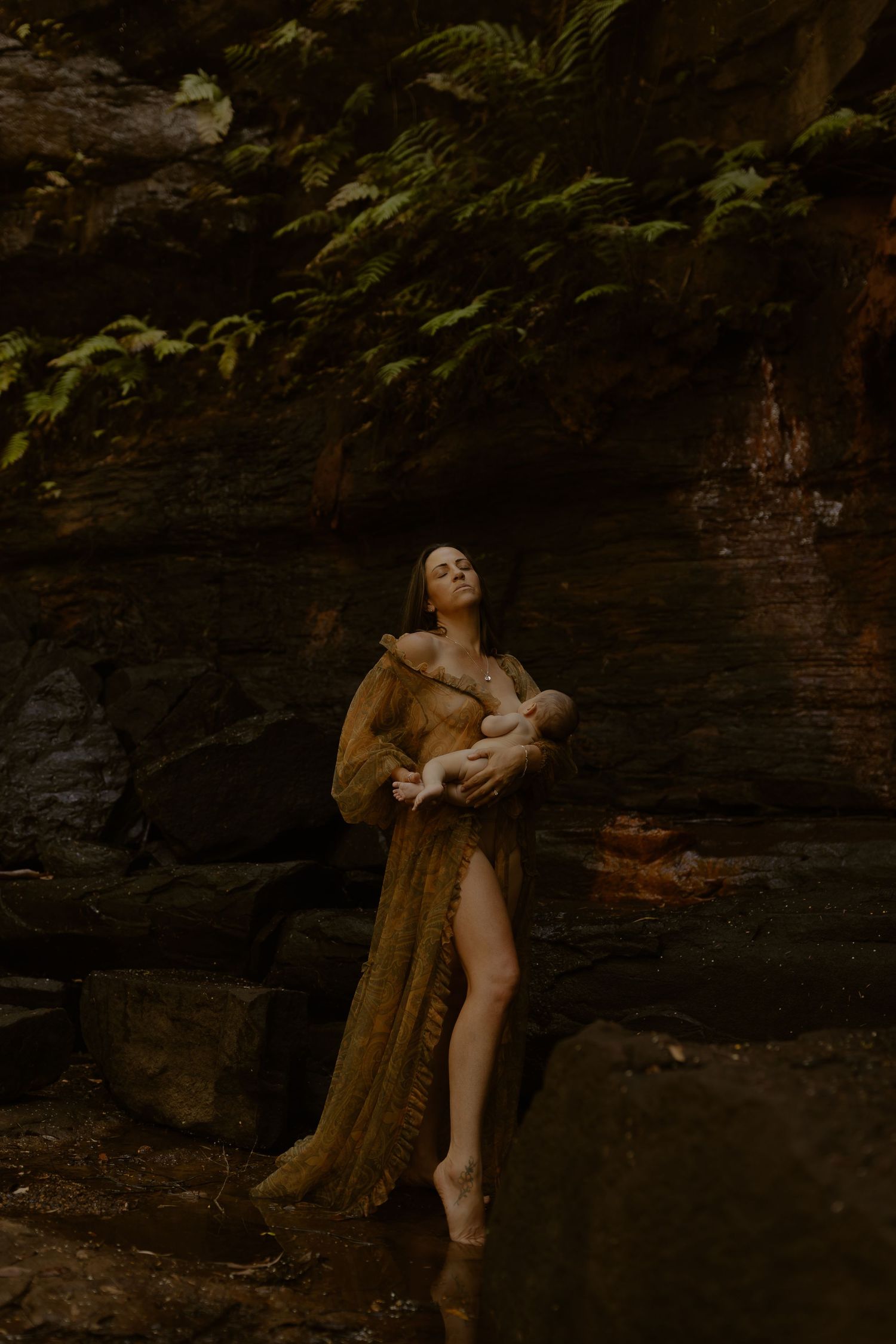Dramatic scene against rocky cliff face with figures in warm earth-toned clothing.