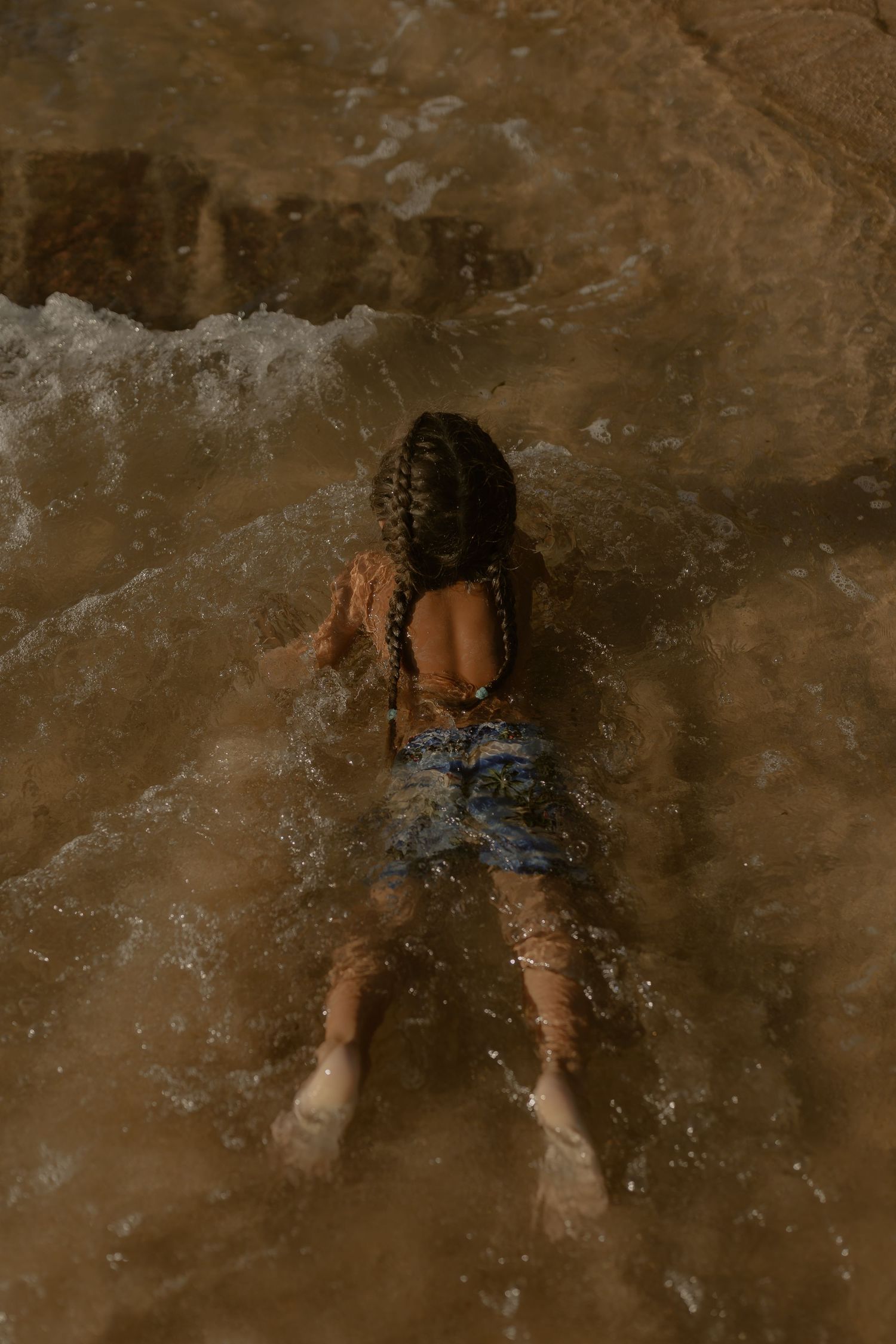 Water splashing and movement captured in a natural rocky setting.
