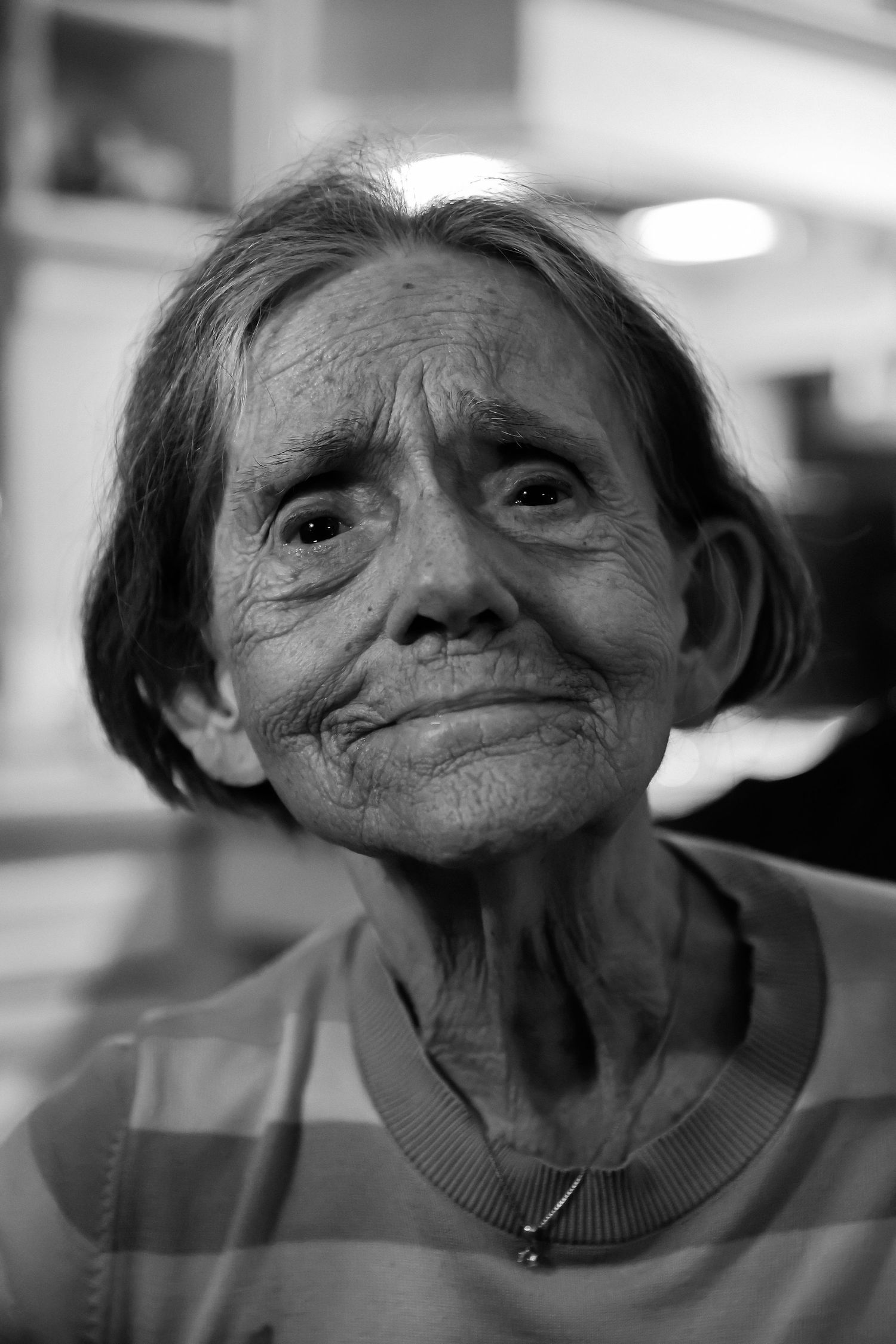 Black and white portrait showing weathered facial features and gentle expression.