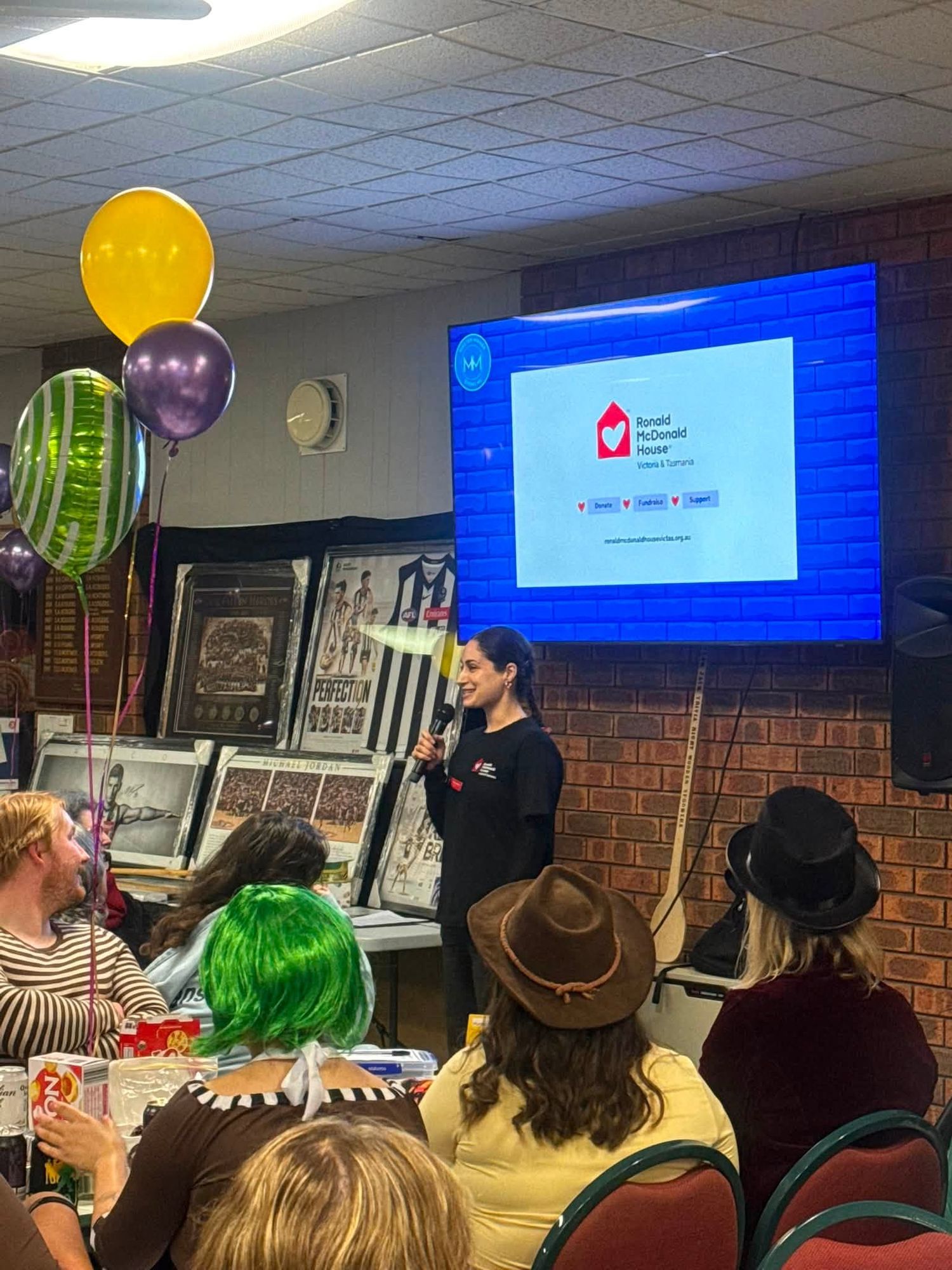 A representative from Ronald McDonald House speaking to the crowd at the Team Jack trivia night