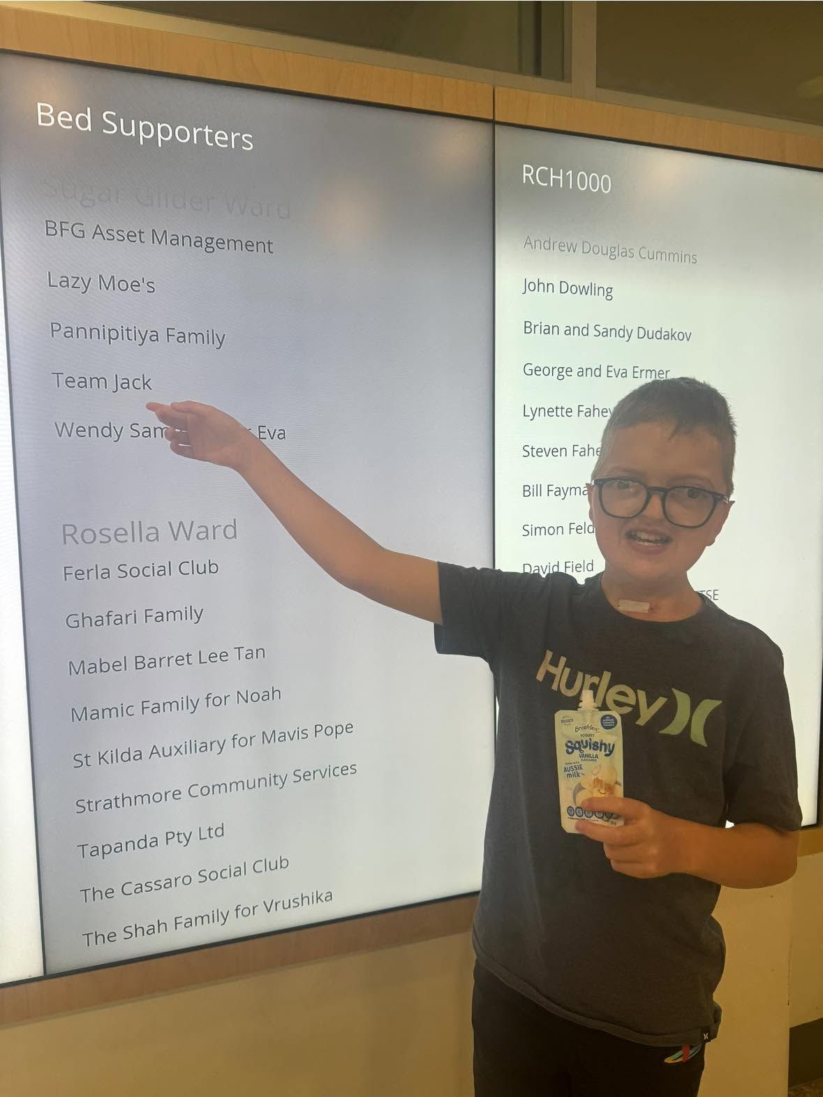 Jack pointing to the Team Jack listing on the Sugar Glider Ward bed supporters board at the Royal Children's Hospital