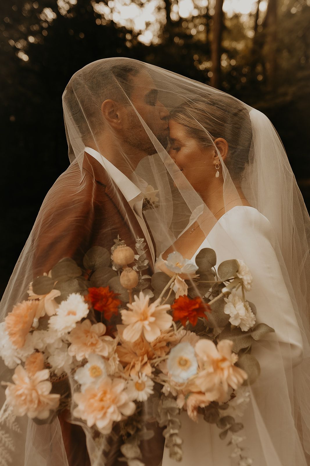 moody veil photos of bride and groom