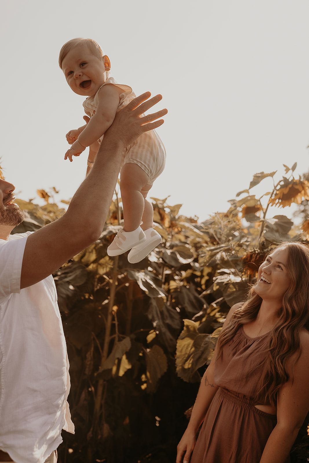 fun family photoshoot in sunflower field