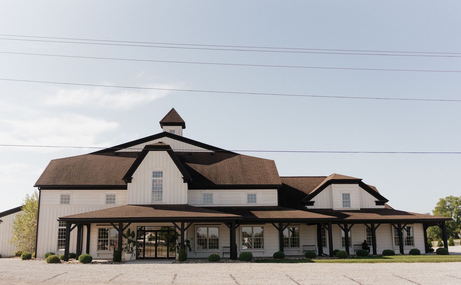 A panoramic view of modern church buildings with sloped roofs and clean architectural lines against a cloudy sky.