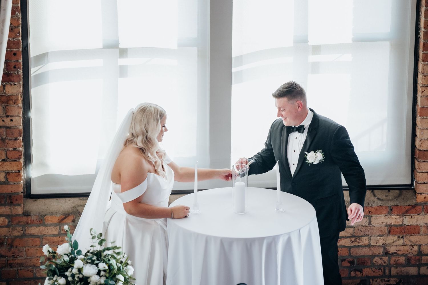 A couple shares an intimate first dance moment at their wedding reception in a bright loft space.