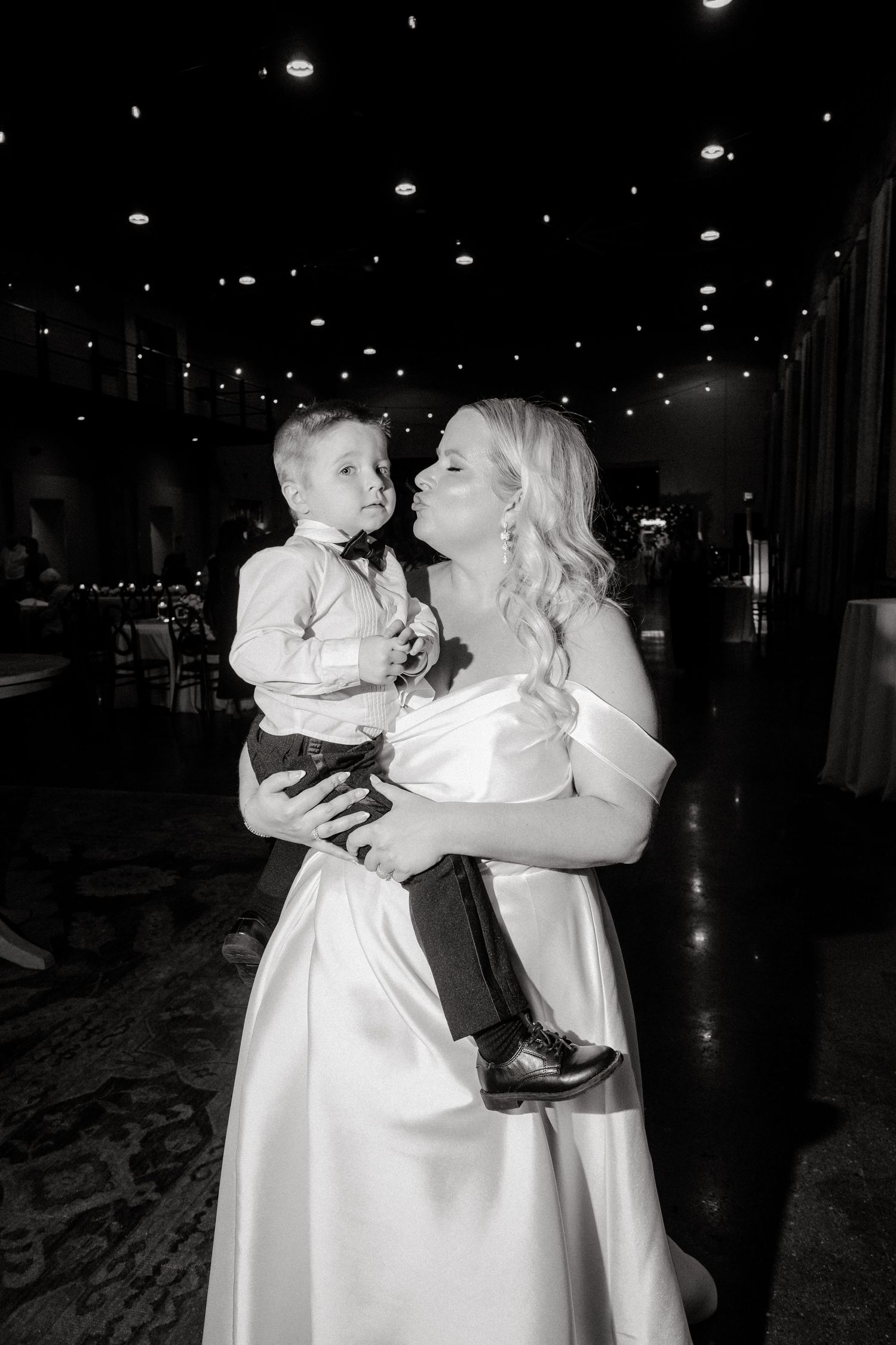 Black and white photo of tender moments during a wedding reception.