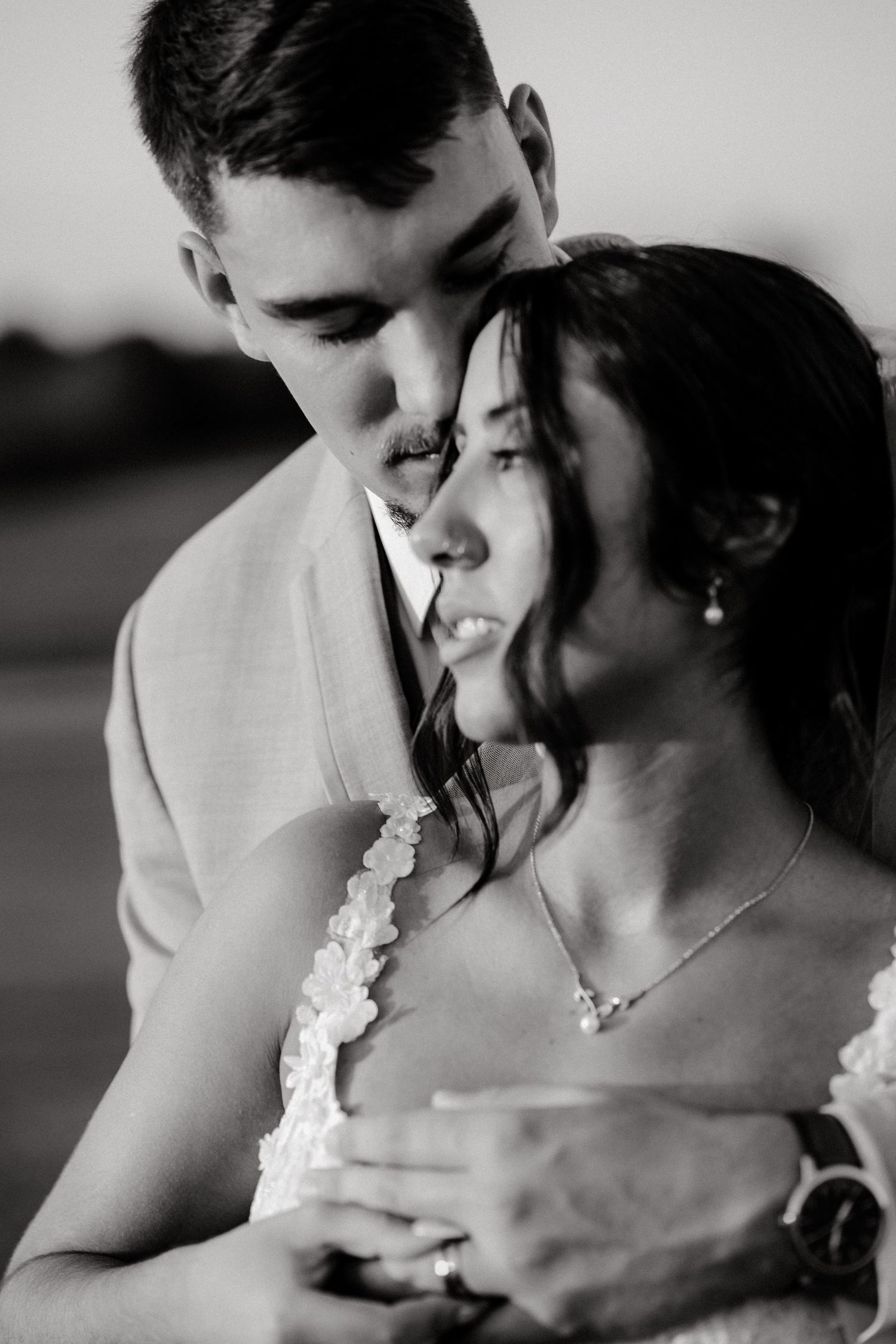Black and white romantic wedding photos show tender moments between newlyweds in an intimate sequence.