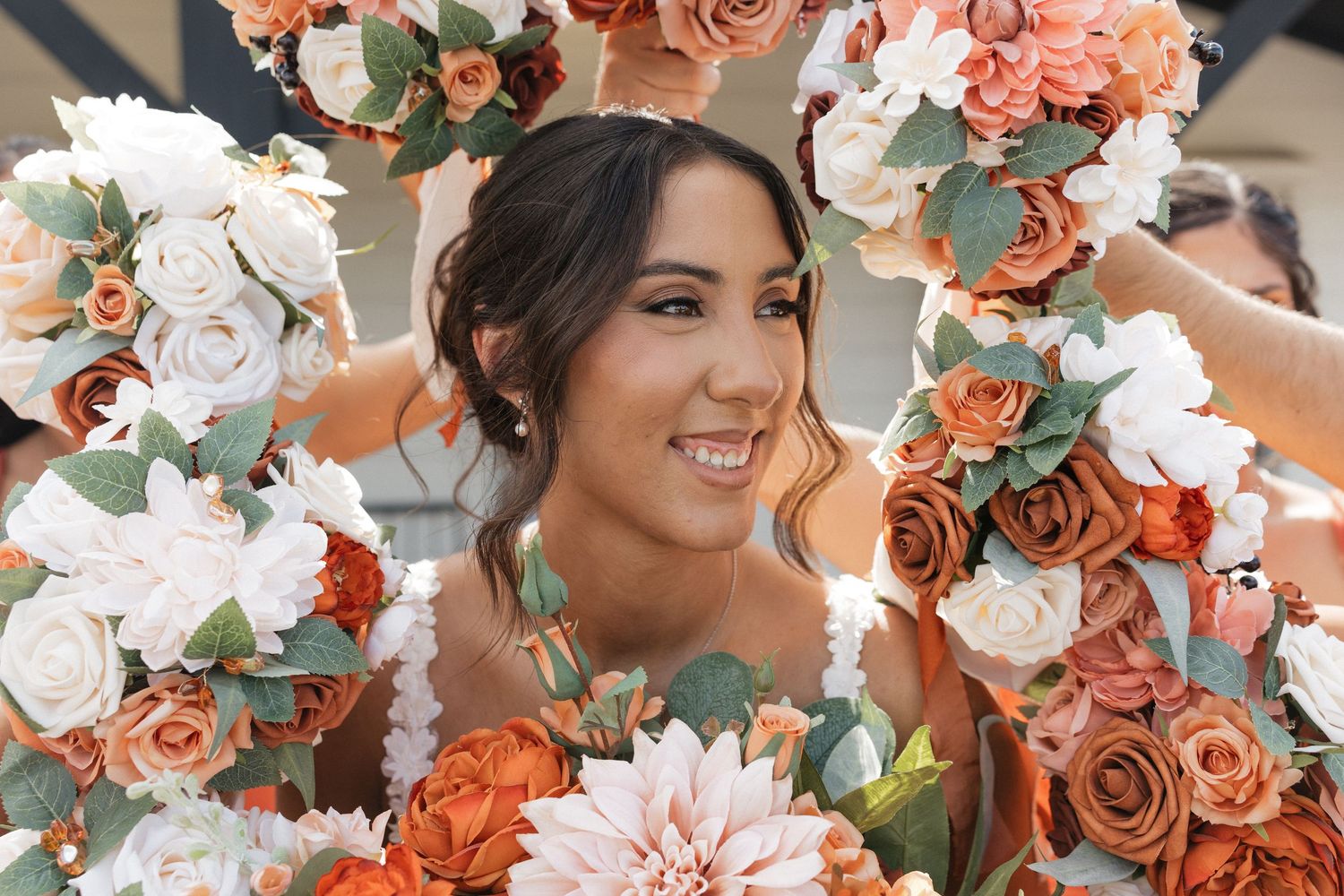 Wedding bouquet arrangement with coral roses, white flowers and eucalyptus leaves.