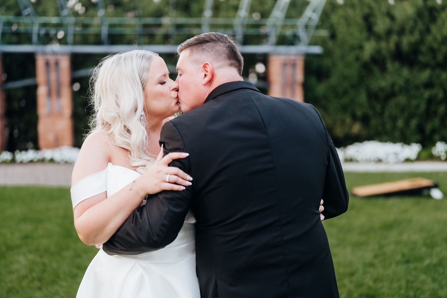 Romantic outdoor wedding portraits captured in a lush garden setting.