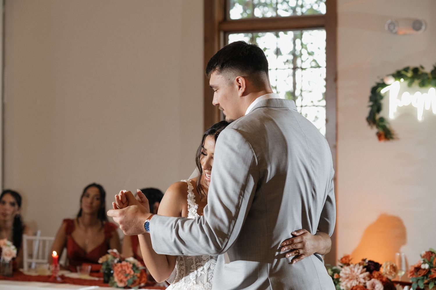 Wedding reception candid moments captured in bright indoor venue.