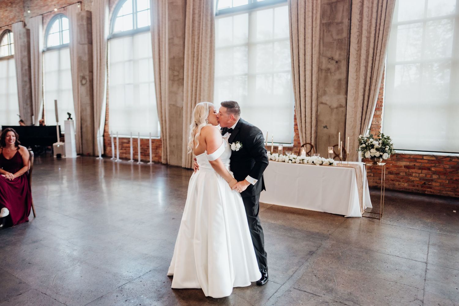 Elegant wedding reception venue with large windows and draped curtains.