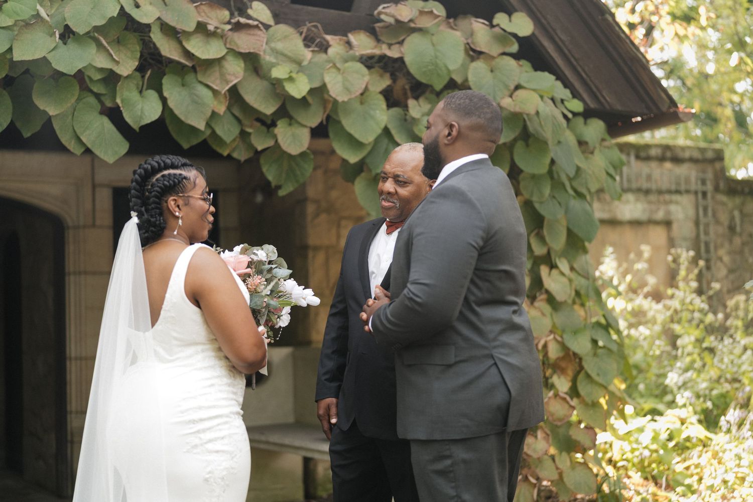 A couple shares an intimate moment during their outdoor garden wedding ceremony.