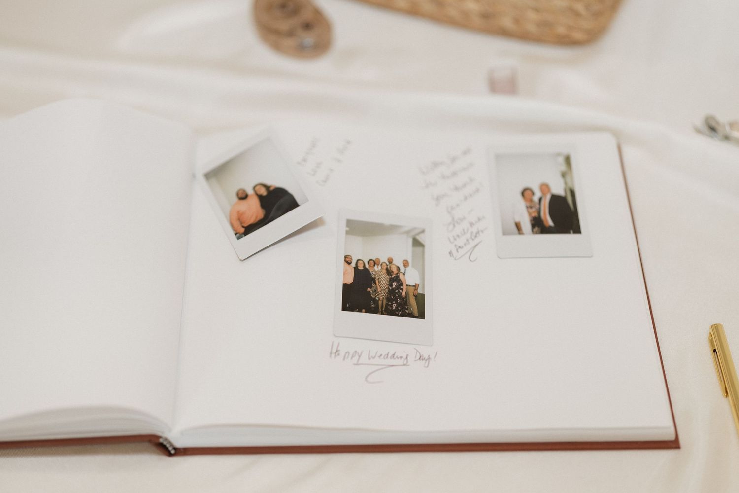 A wedding guest book with polaroid photos and handwritten messages.