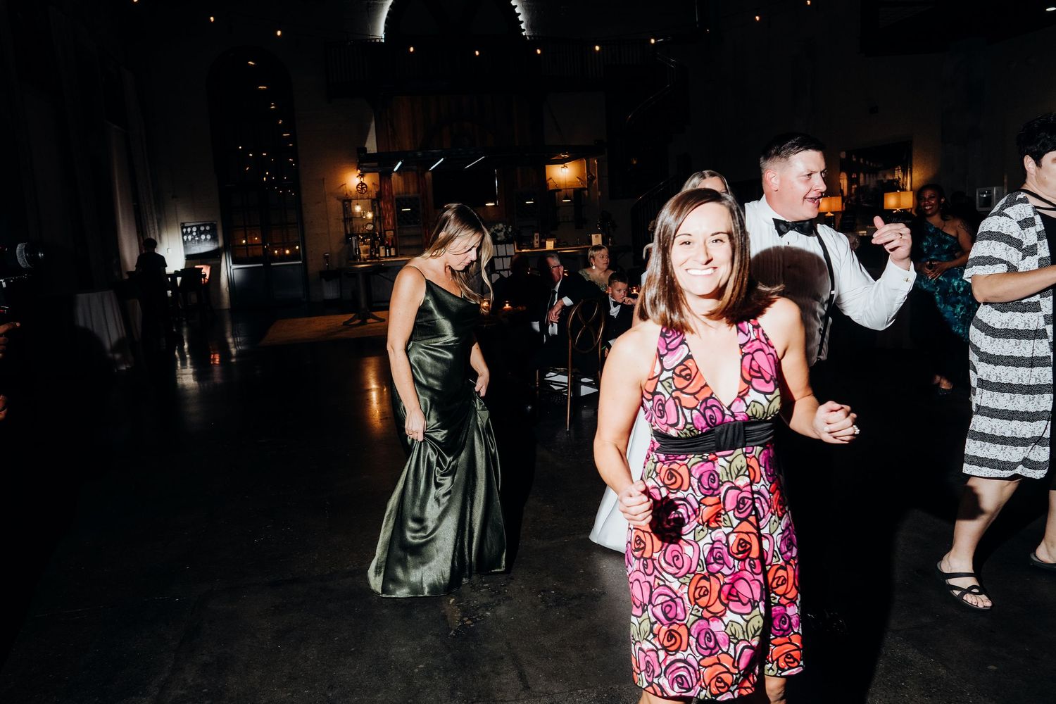 Wedding reception dance floor filled with guests enjoying the celebration at night.