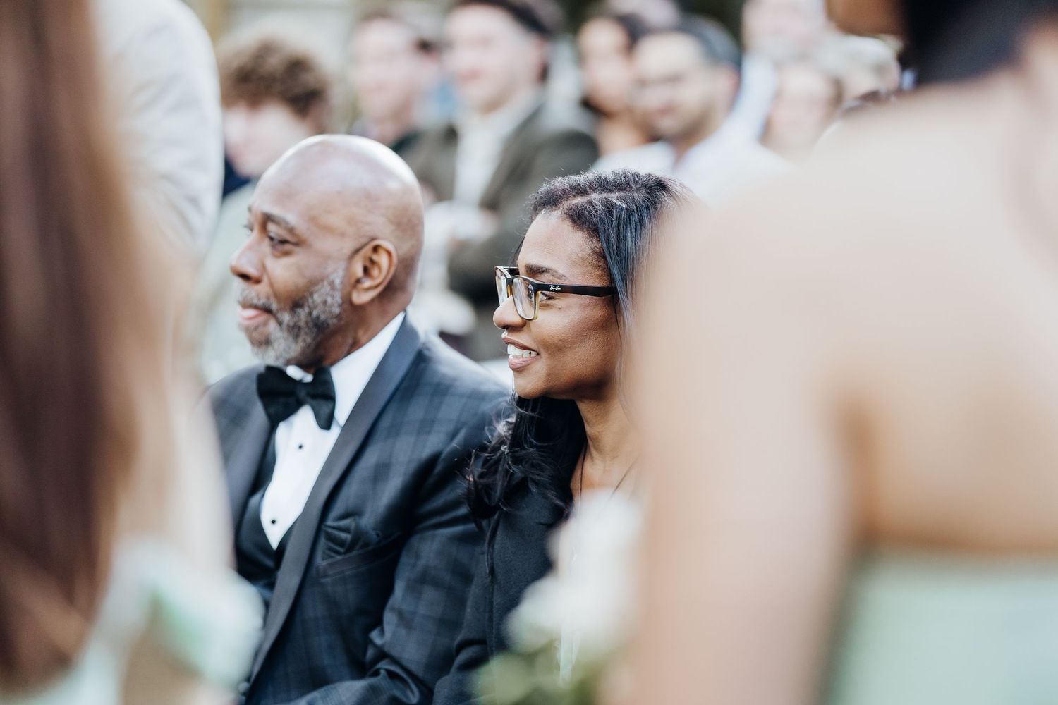 Wedding guests watching the ceremony proceedings with attentive expressions.