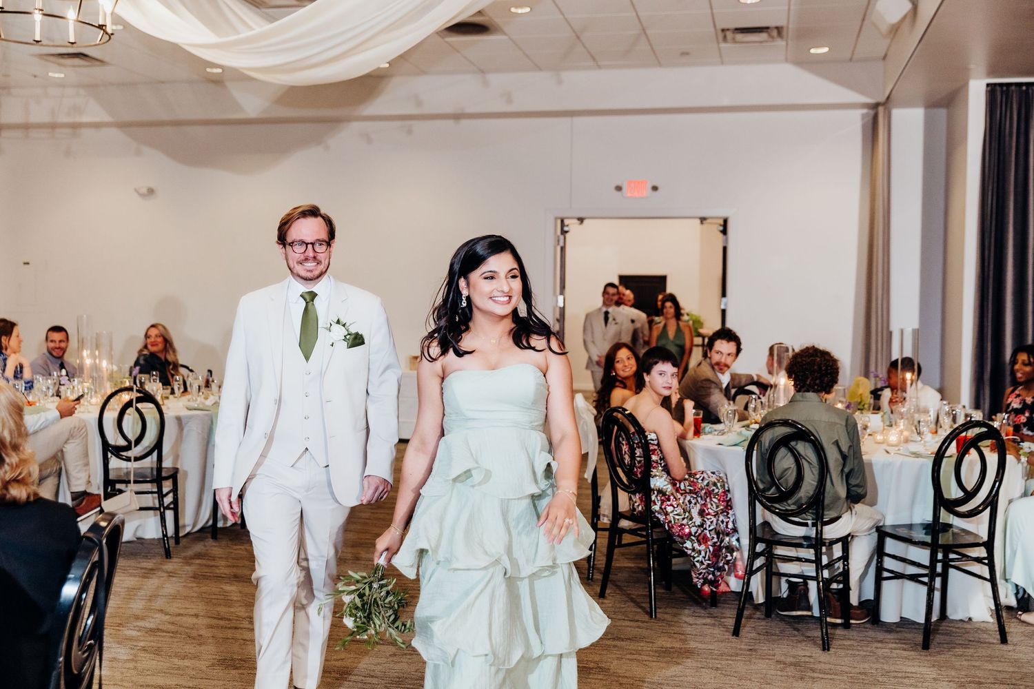 Wedding reception venue with elegant table settings and classic decor.