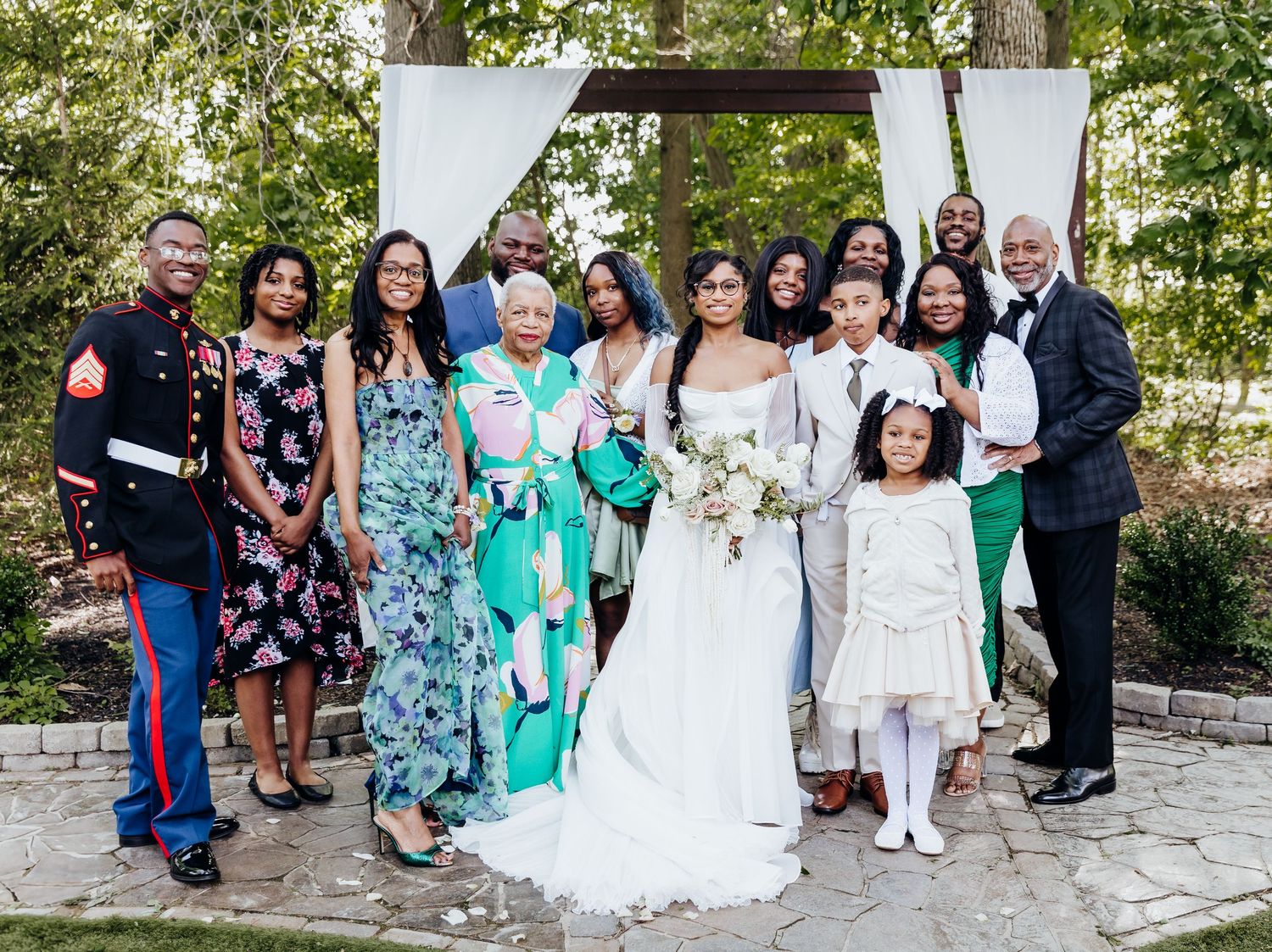 Wedding party and guests pose for group photos outdoors.