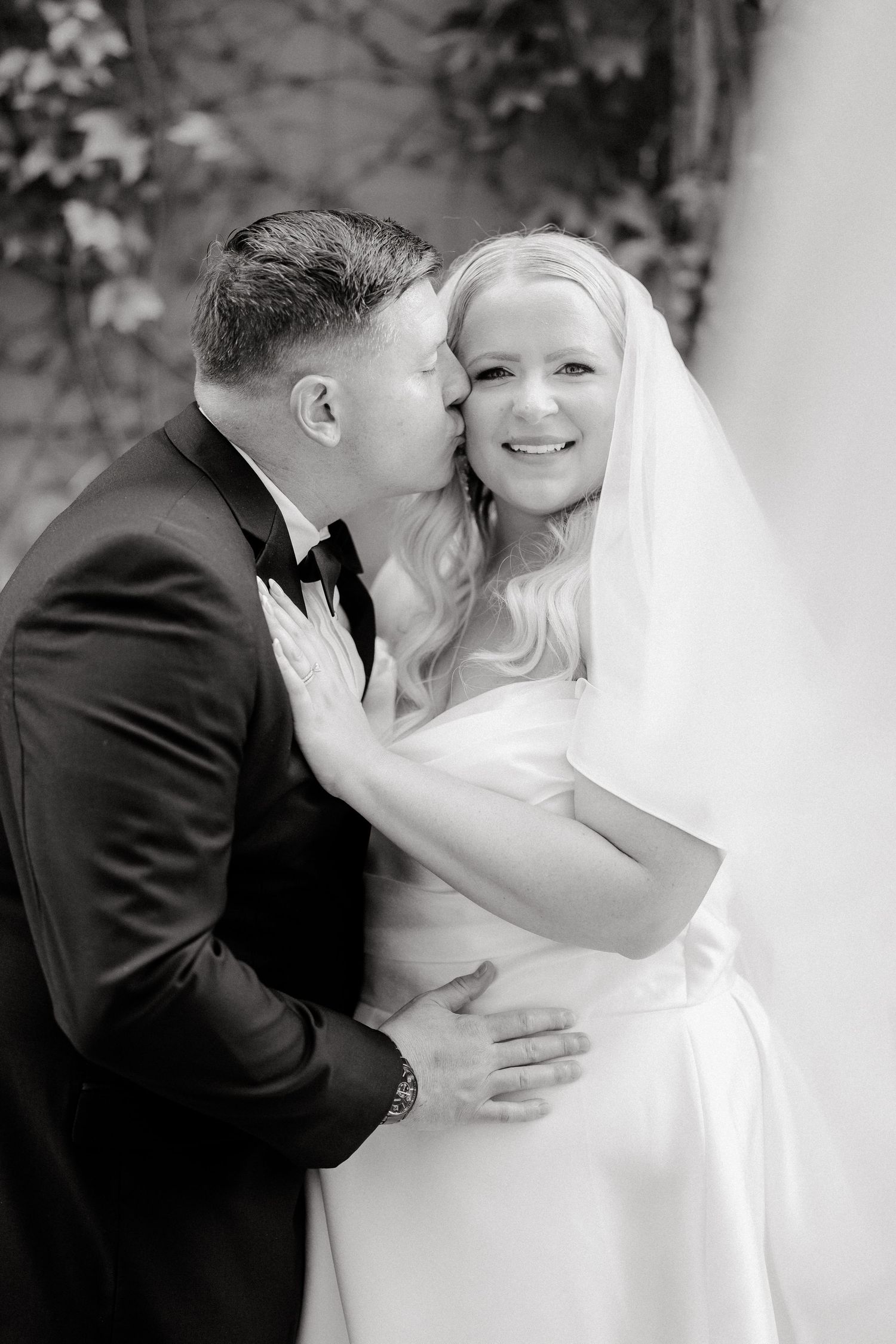 Intimate black and white wedding portraits showing tender moments between newlyweds.