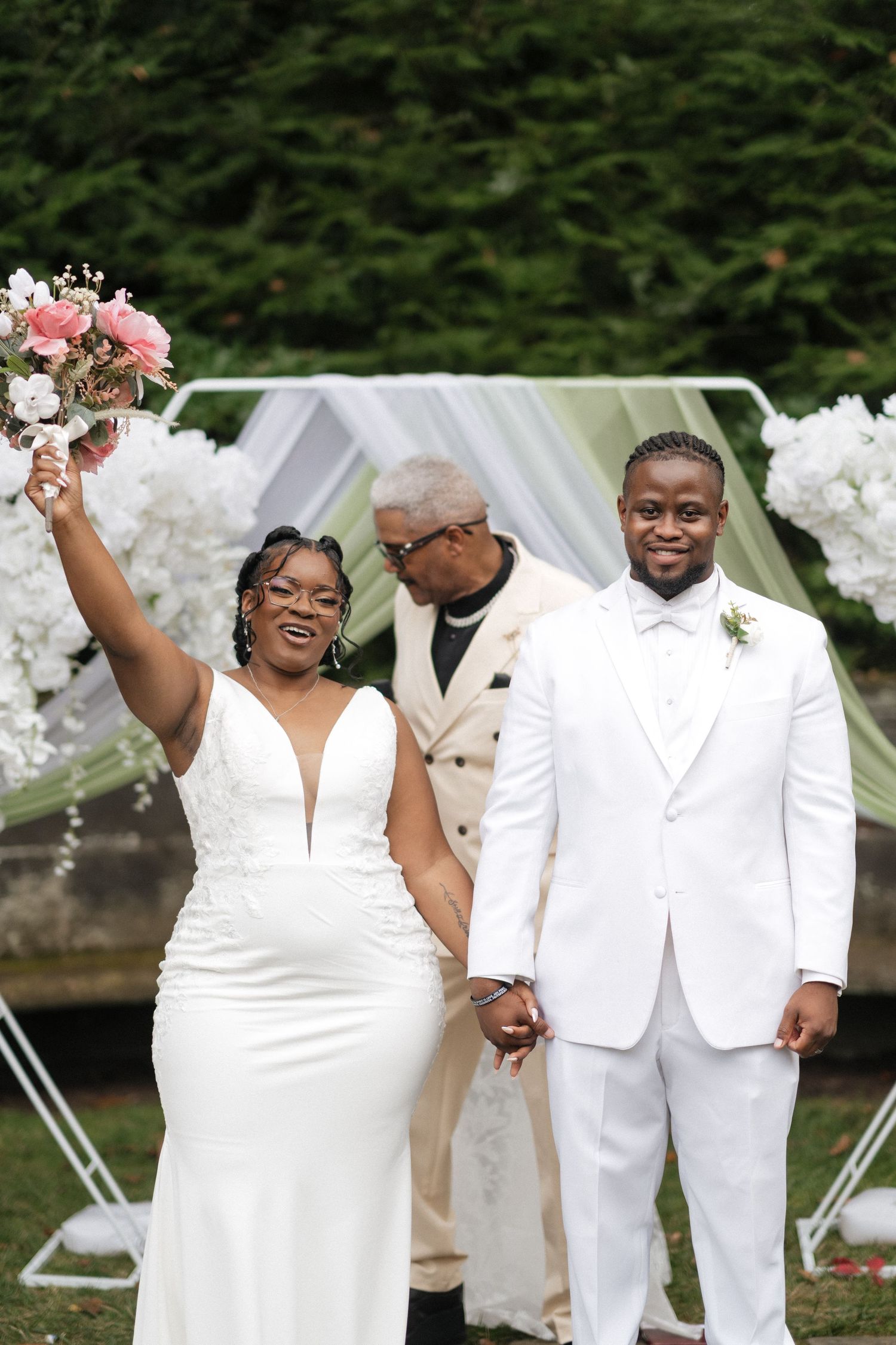 A joyful wedding celebration moment with the couple in elegant white attire.